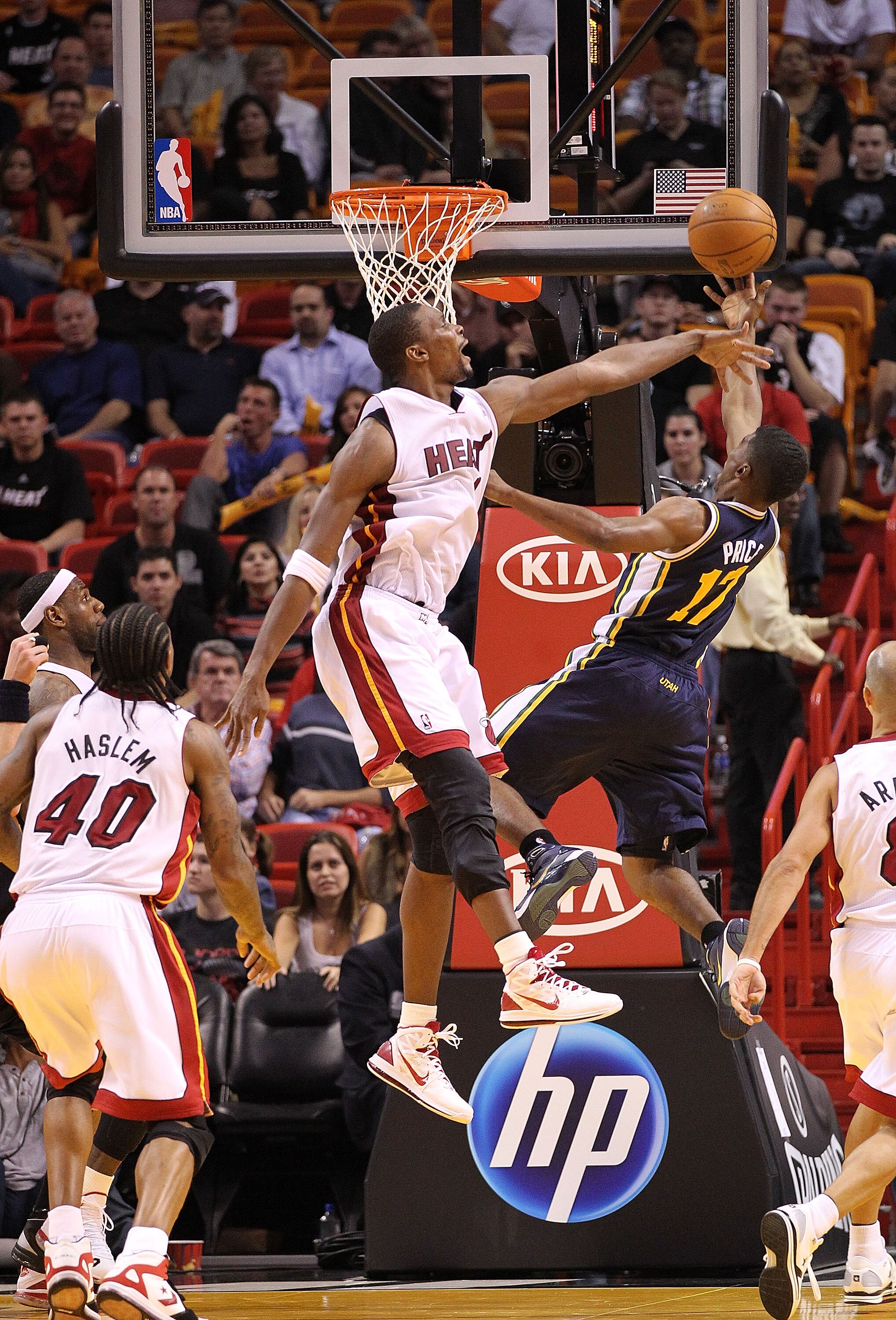MIAMI - NOVEMBER 09: Chris Bosh #1 of the Miami Heat blocks the shot of Earl Watson #11 during a game against the Utah Jazz at American Airlines Arena on November 9, 2010 in Miami, Florida. NOTE TO USER: User expressly acknowledges and agrees that, by dow