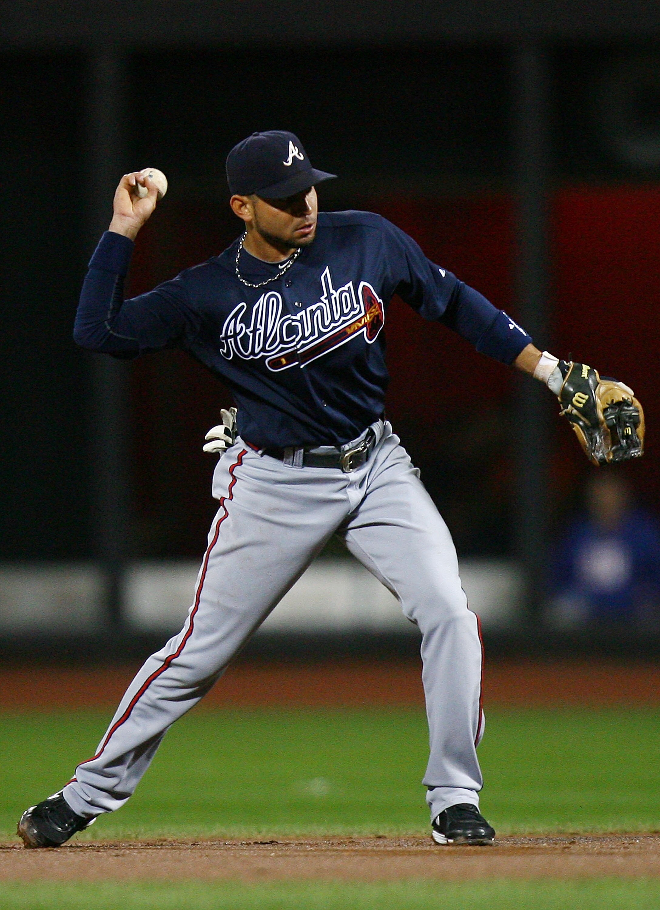 NEW YORK - SEPTEMBER 17:  Omar Infante #4 of the Atlanta Braves fields a ball against the New York Mets on September 17, 2010 at Citi Field in the Flushing neighborhood of the Queens borough of New York City.  (Photo by Andrew Burton/Getty Images)