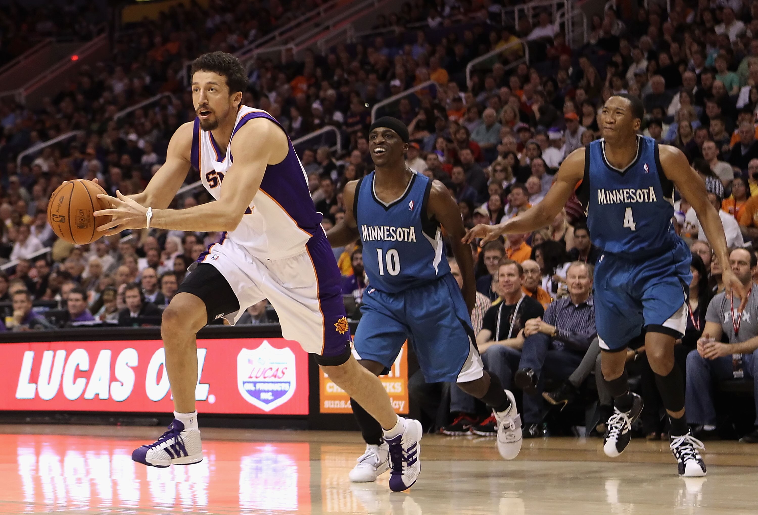 PHOENIX - DECEMBER 15:  Hedo Turkoglu #19 of the Phoenix Suns drives the ball past Jonny Flynn #10 and Wesley Johnson #4 of the Minnesota Timberwolves during the NBA game at US Airways Center on December 15, 2010 in Phoenix, Arizona. The Suns defeated the