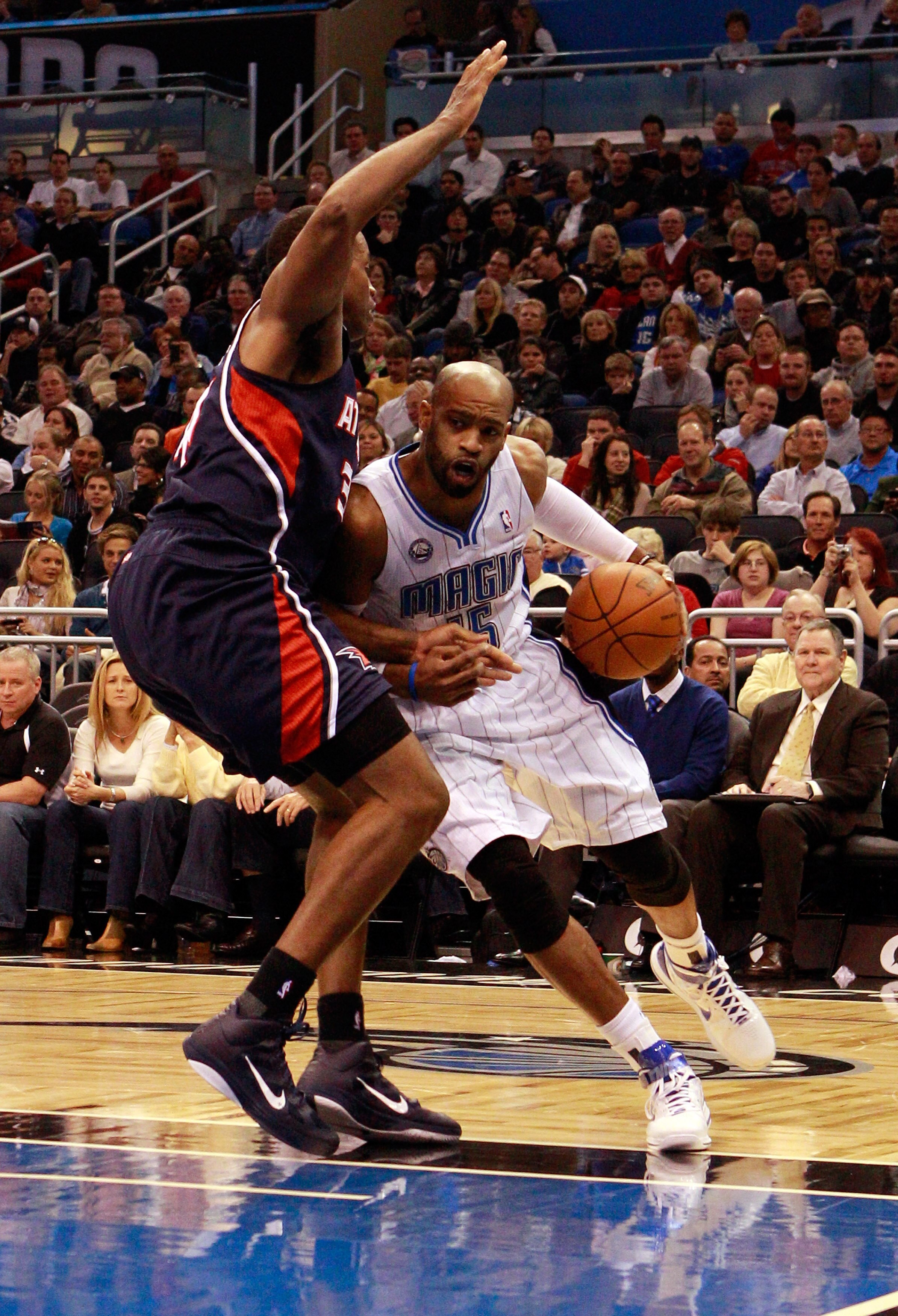 ORLANDO, FL - DECEMBER 06:  Vince Carter, #15 of the Orlando Magic, drives against Jason Collins, #34  of the Atlanta Hawks, during the game at Amway Arena on December 6, 2010 in Orlando, Florida. NOTE TO USER: User expressly acknowledges and agrees that,