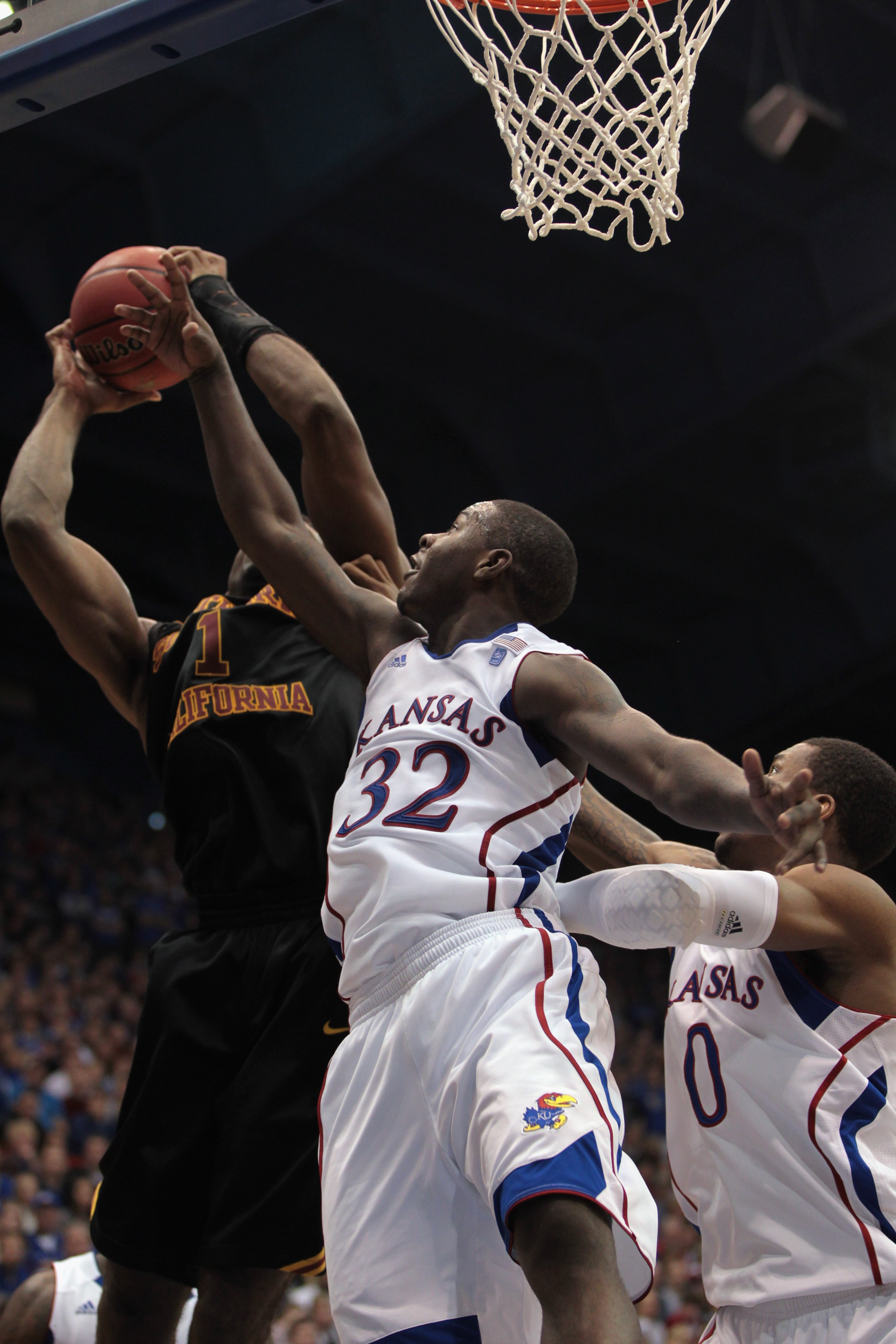 LAWRENCE, KS - DECEMBER 18:  Josh Selby #32 of the Kansas Jayhawks defends against Alex Stepheson #1 of the USC Trojans during the game on December 18, 2010 at Allen Fieldhouse in Lawrence, Kansas.  The Jayhawks defeated the Trojans with a final score of