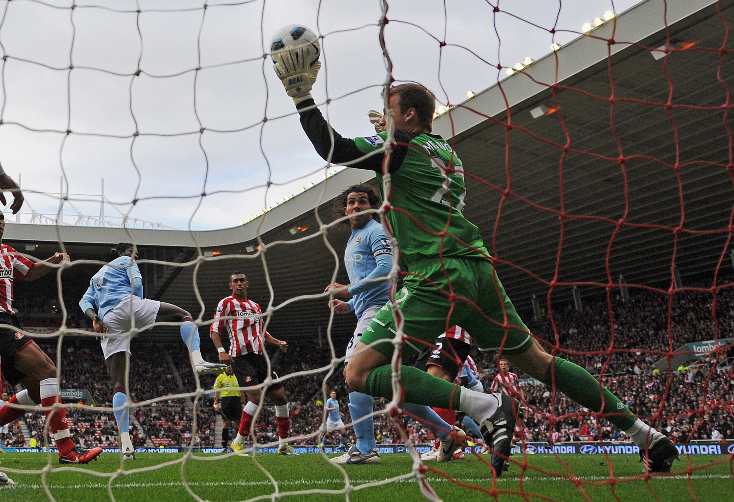 SUNDERLAND, ENGLAND - AUGUST 29: Simon Mignolet of Sunderland saves from Emmanuel Adebayor of Manchester City during the Barclays Premier League match between Sunderland and Manchester City at the Stadium of Light on August 29, 2010 in Sunderland, England SUNDERLAND, ENGLAND - AUGUST 29: Simon Mignolet of Sunderland saves from Emmanuel Adebayor of Manchester City during the Barclays Premier League match between Sunderland and Manchester City at the Stadium of Light on August 29, 2010 in Sunderland, England