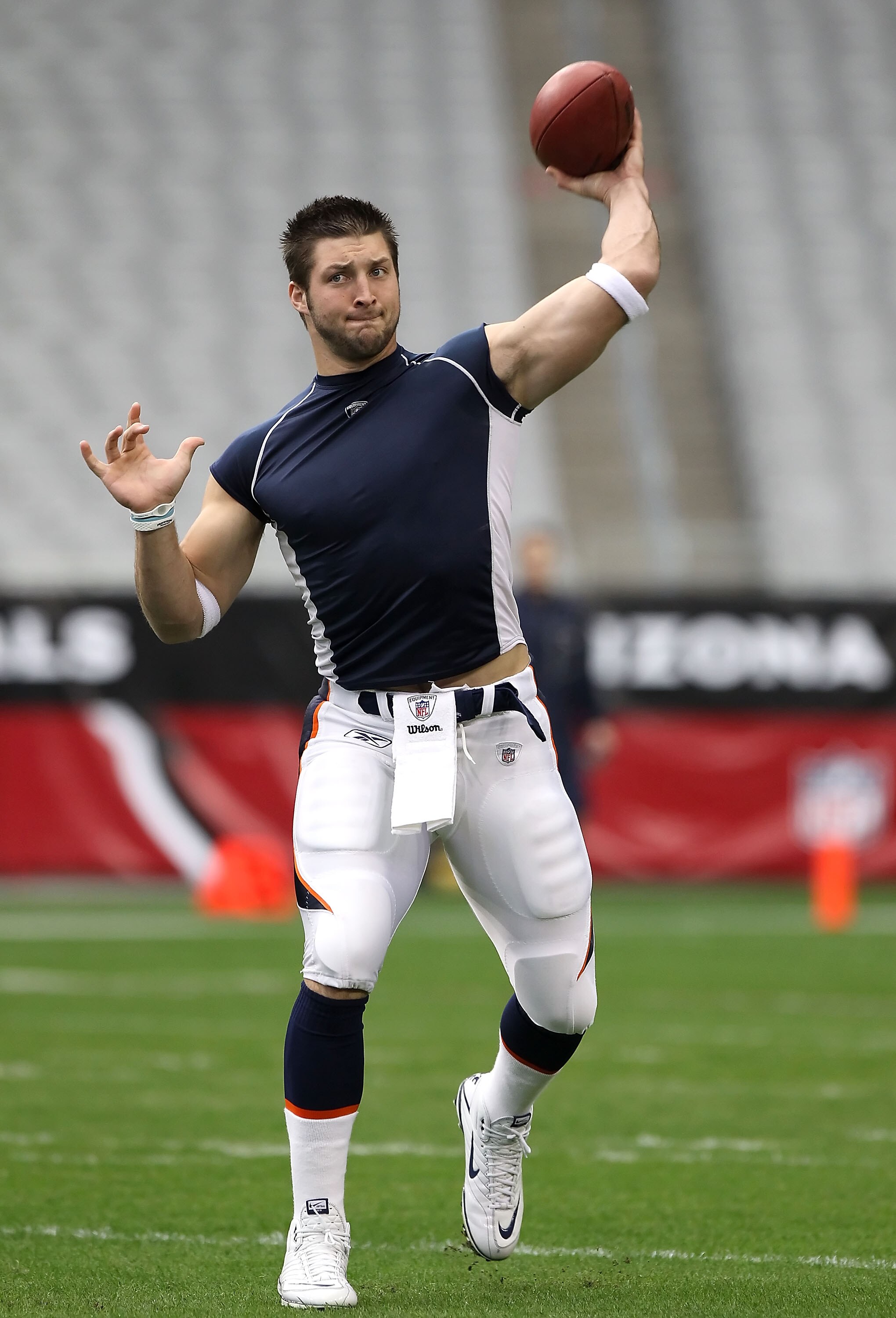 GLENDALE, AZ - DECEMBER 12:  Quarterback Tim Tebow #15 of the Denver Broncos warms up before the NFL game against the Arizona Cardinals at the University of Phoenix Stadium on December 12, 2010 in Glendale, Arizona.   The Cardinals defeated the Broncos 43