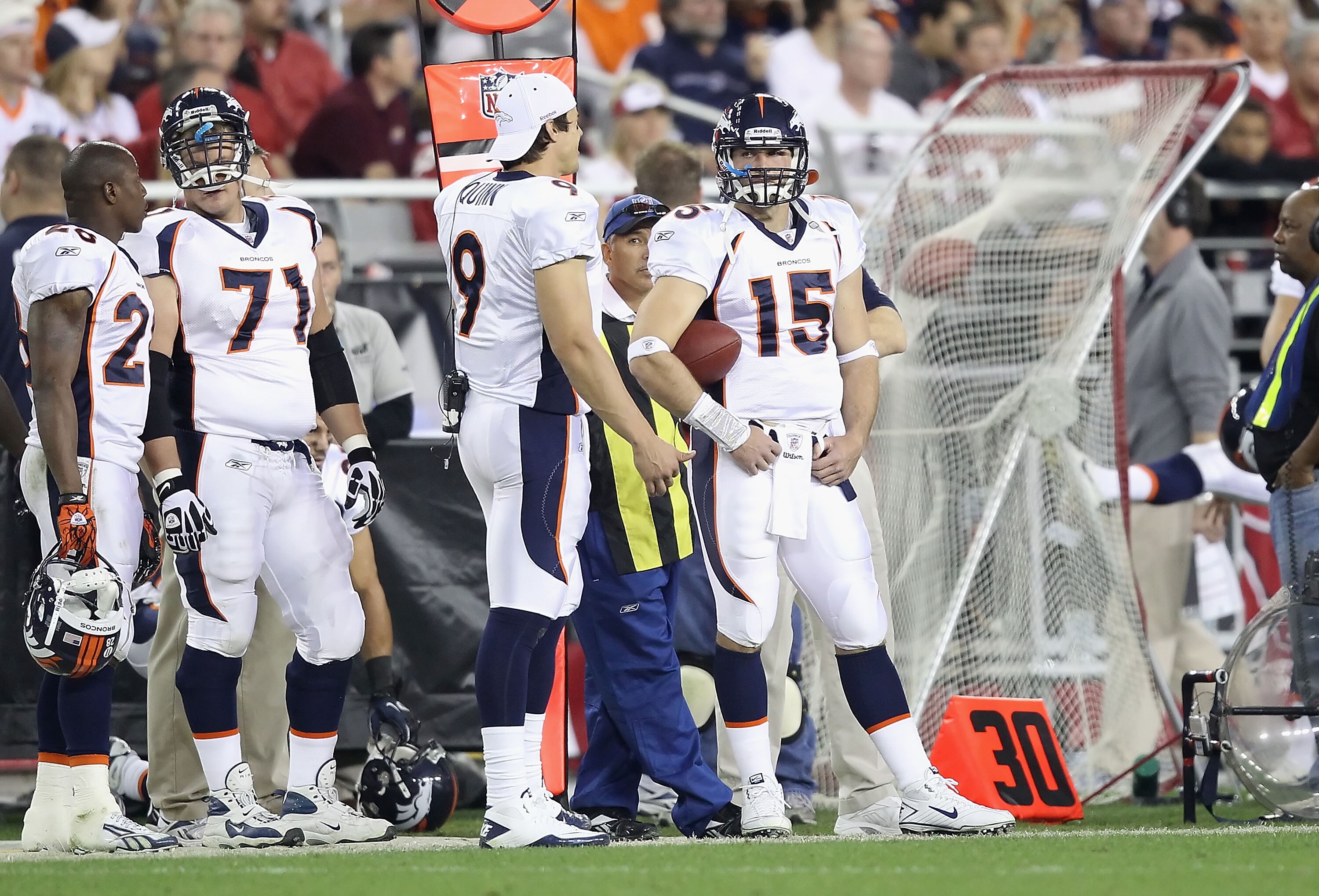 GLENDALE, AZ - DECEMBER 12:  Quarterbacks Brady Quinn #9 and Tim Tebow #15 of the Denver Broncos stand on the sideline during the NFL game against the Arizona Cardinals at the University of Phoenix Stadium on December 12, 2010 in Glendale, Arizona.   The