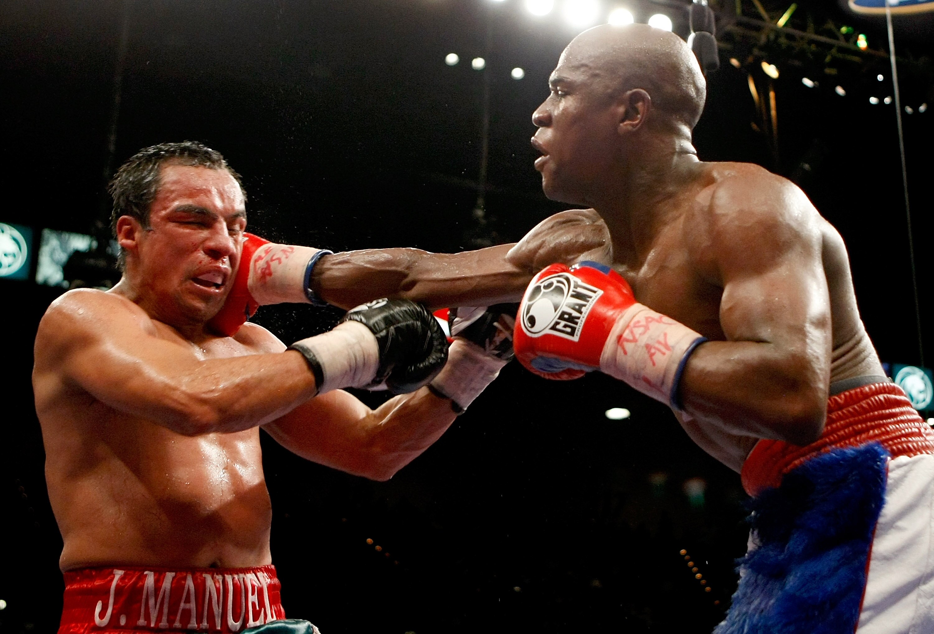 LAS VEGAS - SEPTEMBER 19:  Floyd Mayweather Jr. (R) hits Juan Manuel Marquez in the 11th round of their fight at the MGM Grand Garden Arena September 19, 2009 in Las Vegas, Nevada. Mayweather won by unanimous decision.  (Photo by Ethan Miller/Getty Images