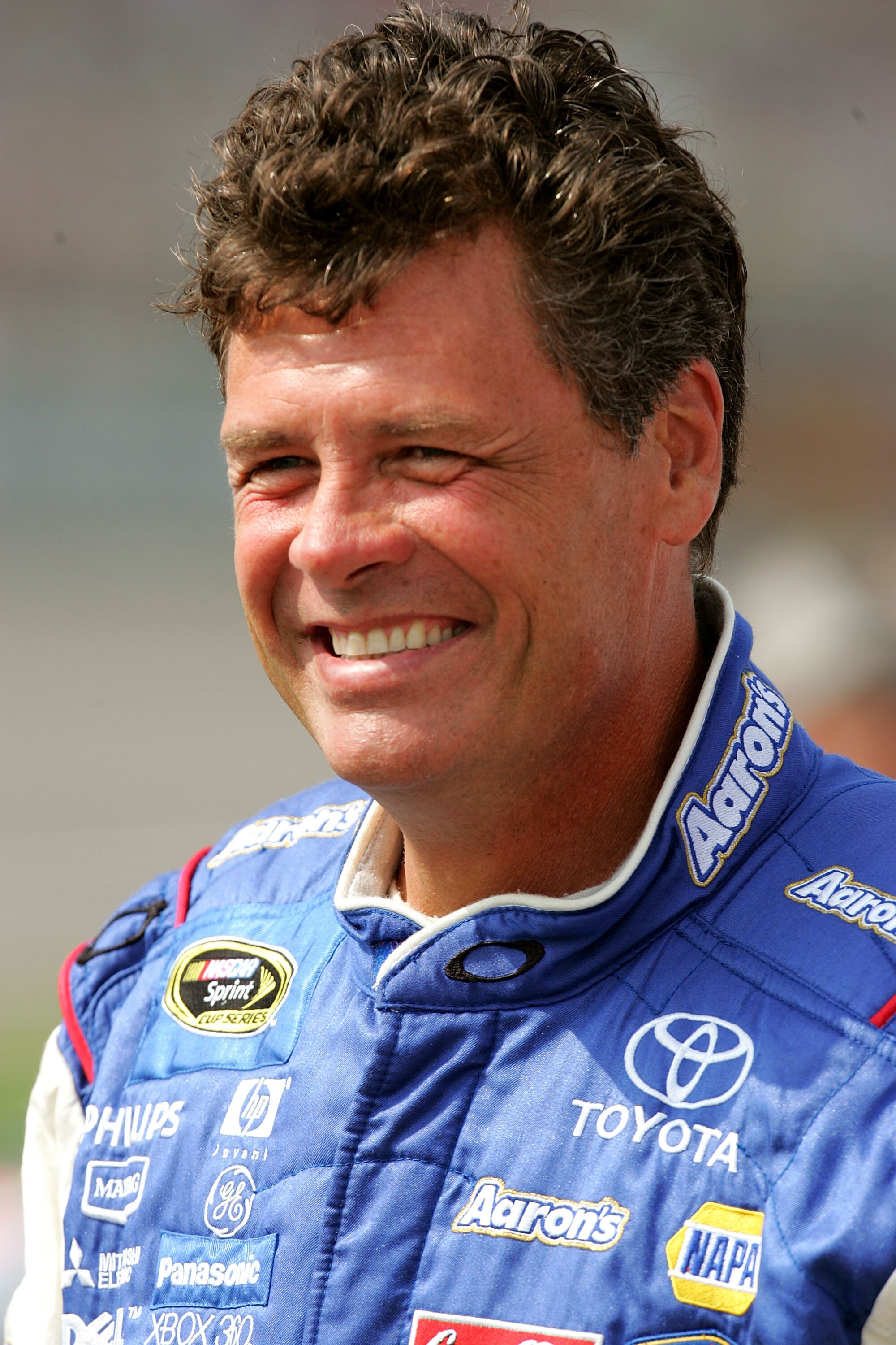 BROOKLYN, MI - JUNE 11: Michael Waltrip, driver of the #55 PRISM Motorsports Toyota, stands on the grid during qualifying for the NASCAR Sprint Cup Series Heluva Good! Sour Cream Dips 400 at Michigan International Speedway on June 11, 2010 in Brooklyn, Mi