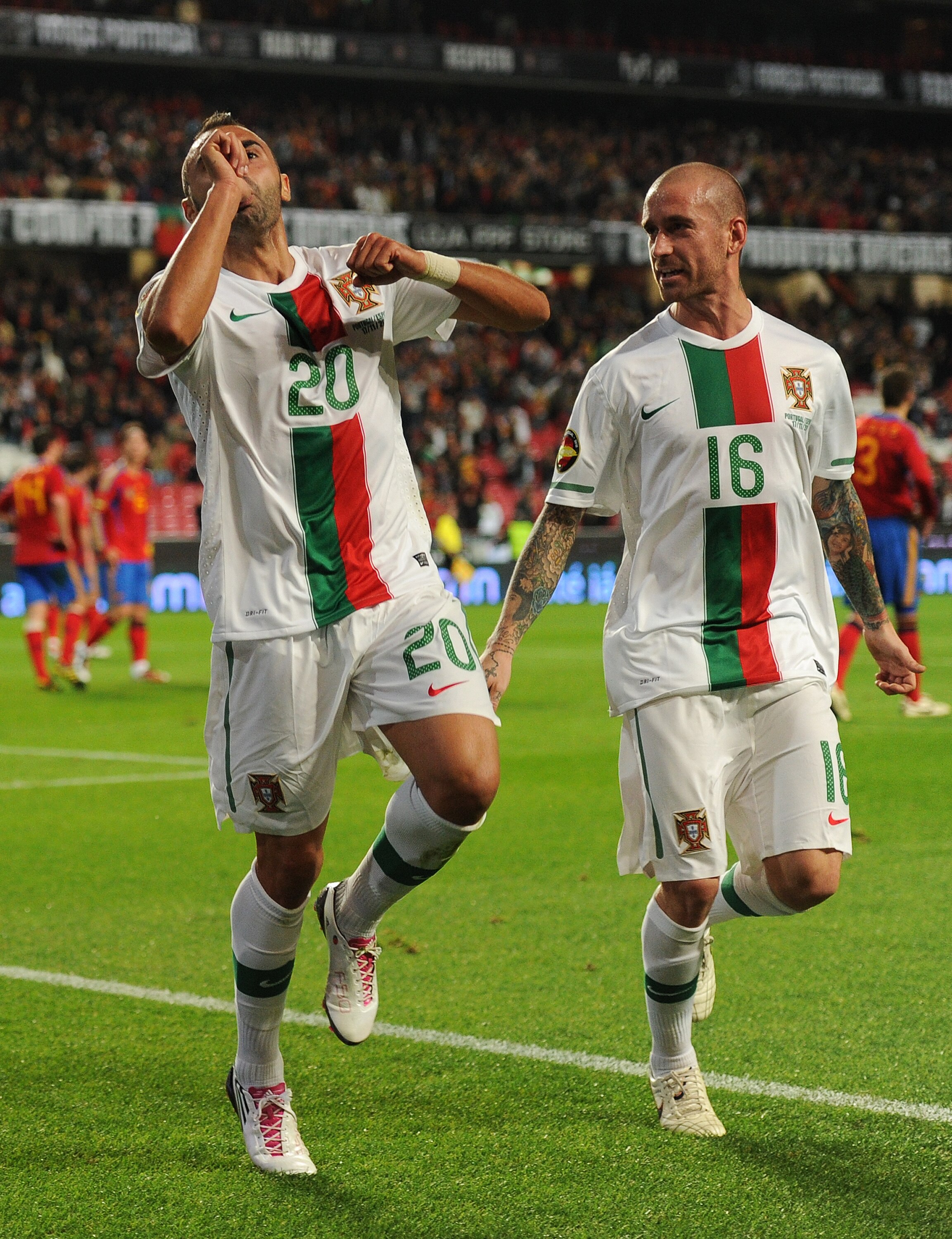 LISBON, PORTUGAL - NOVEMBER 17:  Carlos Martins (L) of Portugal celebrates scoring his sides opening goal with his teammate Raul Meireles during the International Friendly match between Portugal and Spain at the Estadio da Luz on November 17, 2010 in Lisb