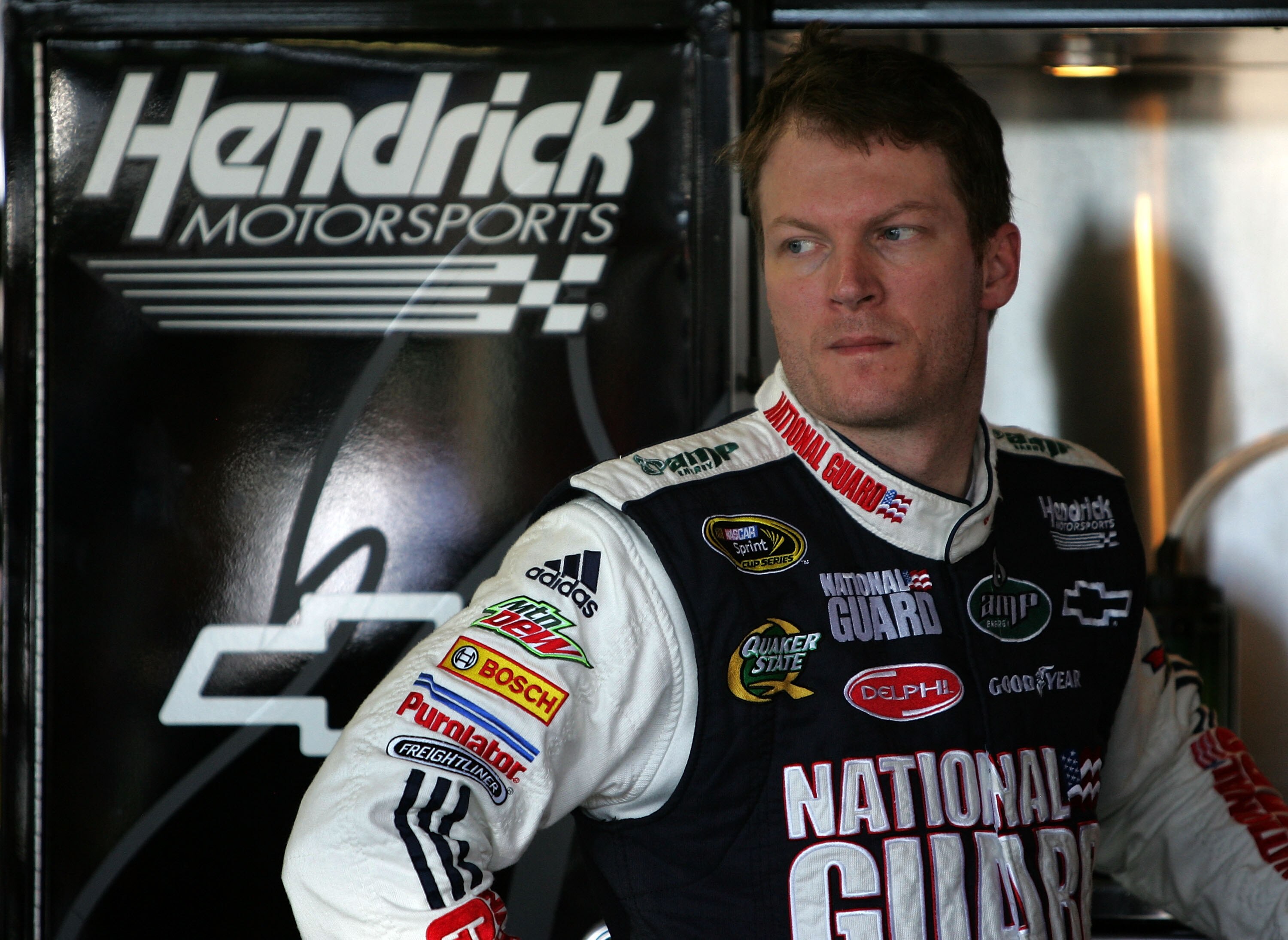 KANSAS CITY, KS - OCTOBER 01:  Dale Earnhardt Jr., driver of the #88 National Guard/AMP Energy Chevrolet, stands in the garage during practice for the NASCAR Sprint Cup Series Price Chopper 400 on October 1, 2010 in Kansas City, Kansas.  (Photo by Christa