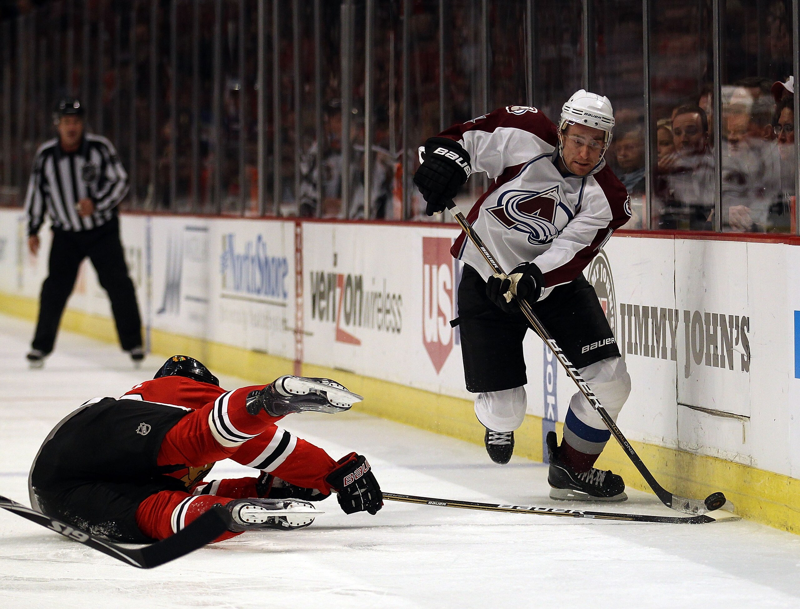 CHICAGO, IL - DECEMBER 15: Jack Skille #20 of the Chicago Blackhawks falls while trying to knock the puck away from Tomas Fleischmann #14 of the Colorado Avalanche at the United Center on December 15, 2010 in Chicago, Illinois. The Avalanche defeated the 