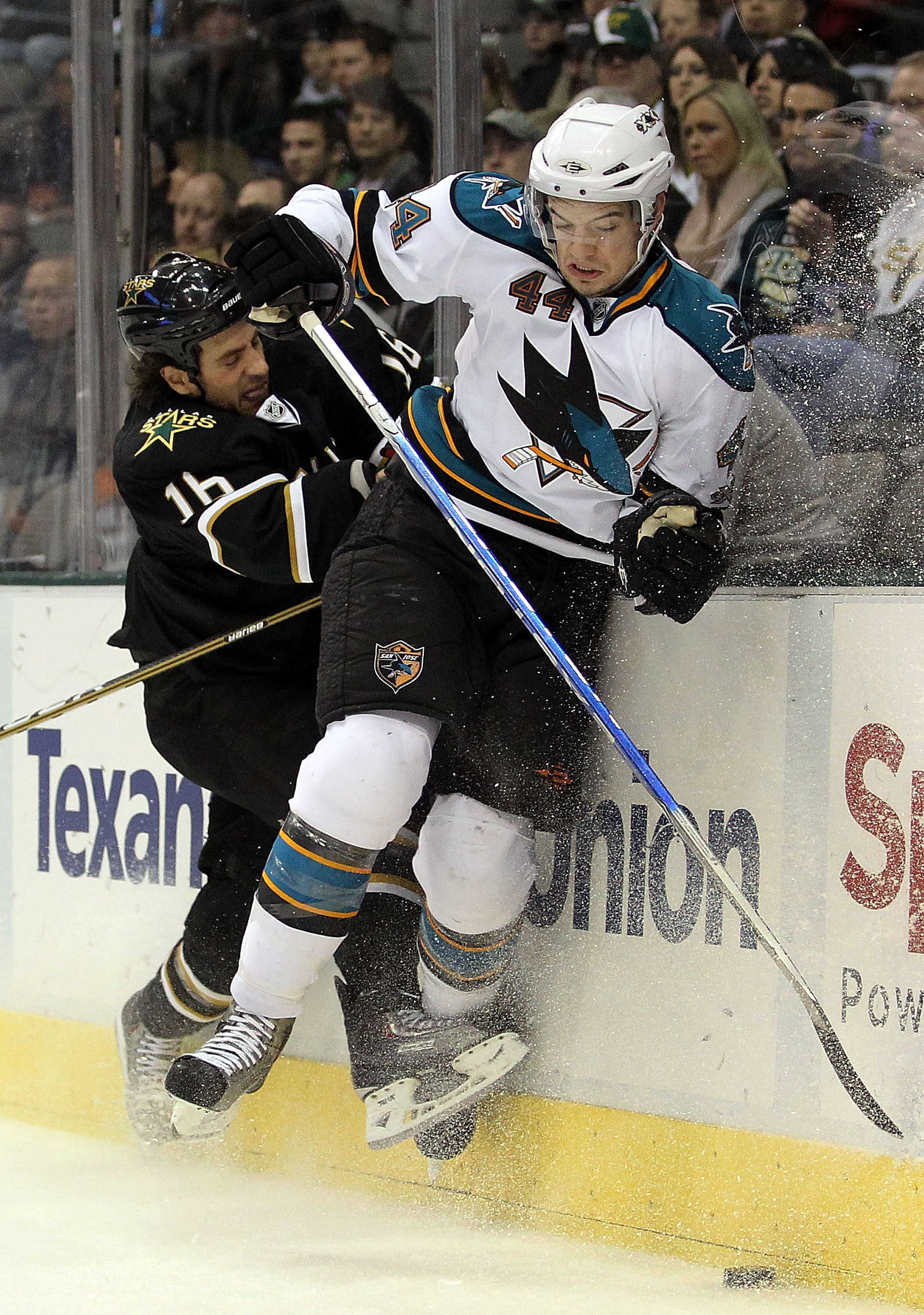 DALLAS, TX - DECEMBER 16:  Defenseman Marc-Edouard Vlasic #44 of the San Jose Sharks is checked by Adam Burish #16 of the Dallas Stars at American Airlines Center on December 16, 2010 in Dallas, Texas.  (Photo by Ronald Martinez/Getty Images)