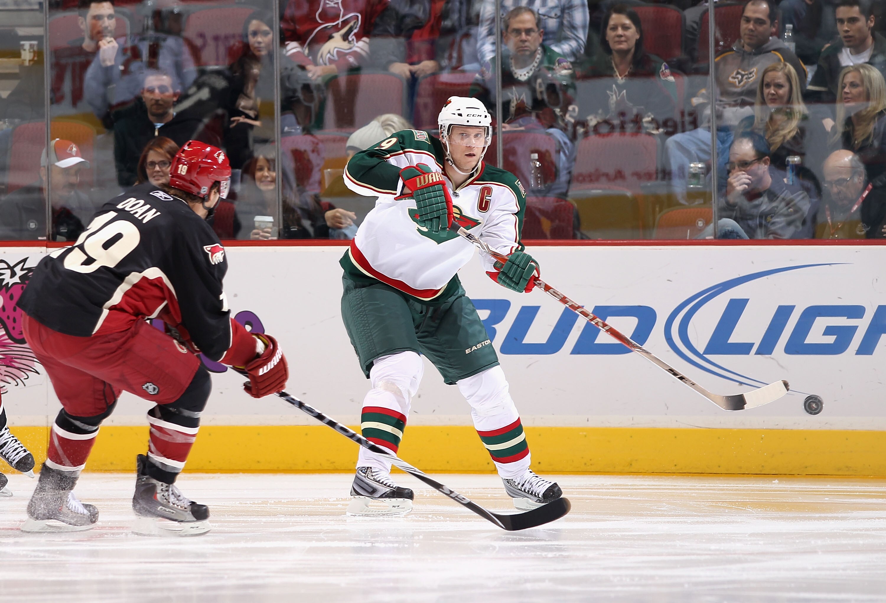 GLENDALE, AZ - DECEMBER 09:  Mikko Koivu #9 of the Minnesota Wild passes the puck during the NHL game against the Phoenix Coyotes at Jobing.com Arena on December 9, 2010 in Glendale, Arizona.  The Wild defeated the Coyotes 3-2.  (Photo by Christian Peters