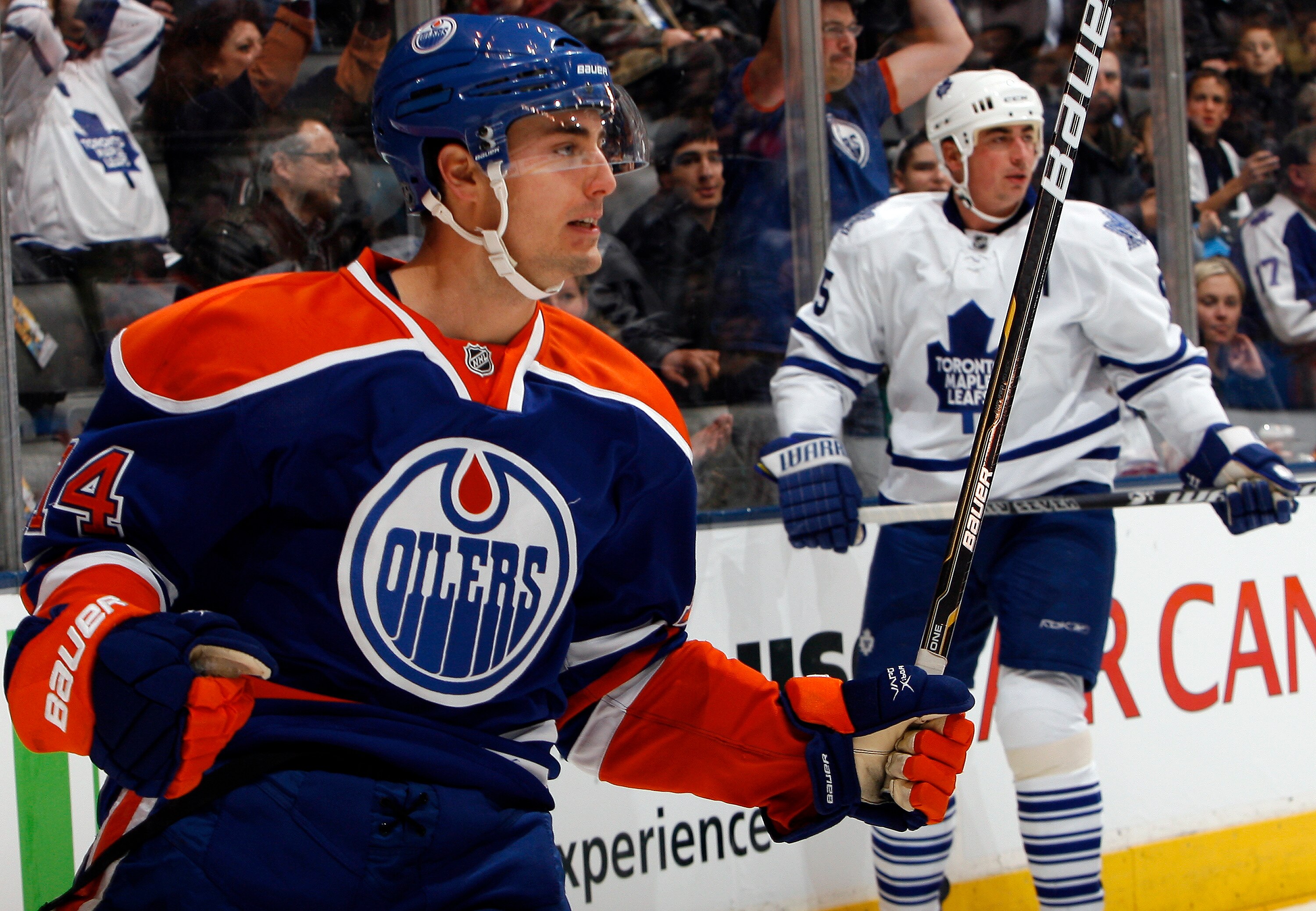 TORONTO, CANADA - DECEMBER 2: Tomas Kaberle #15 of the Toronto Maple Leafs watches as Jordan Eberle #14 of the Edmonton Oilers celebrates his goal during game action at the Air Canada Centre December 2, 2010 in Toronto, Ontario, Canada. (Photo by Abelimag