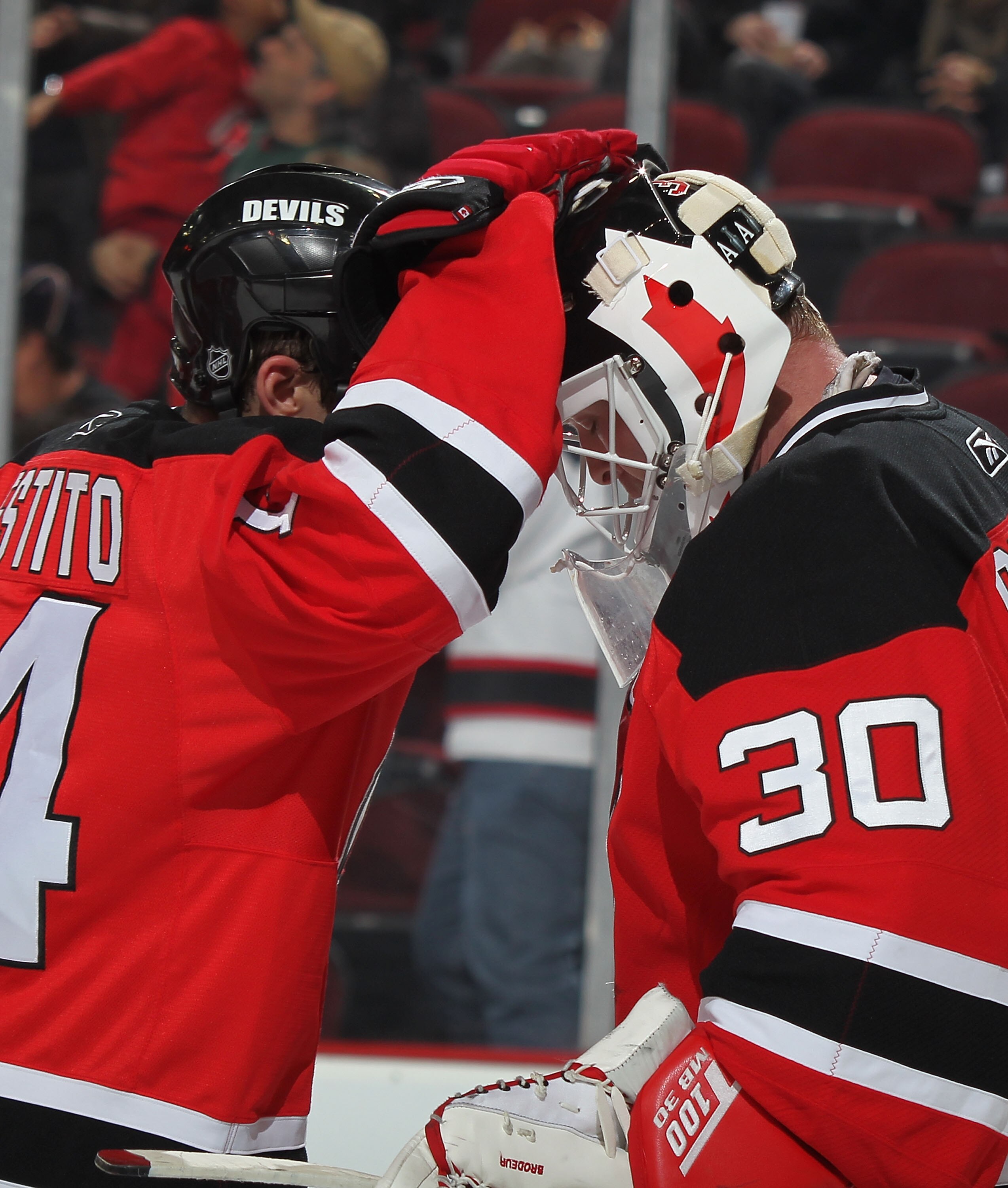 NEWARK, NJ - DECEMBER 15:  Goalie Martin Brodeur #30 of the New Jersey Devils is congratulated by Devils Tim Sestito #14 after a shutout win in a hockey game against the Phoenix Coyotes at the Prudential Center on December 15, 2010 in Newark, New Jersey. 