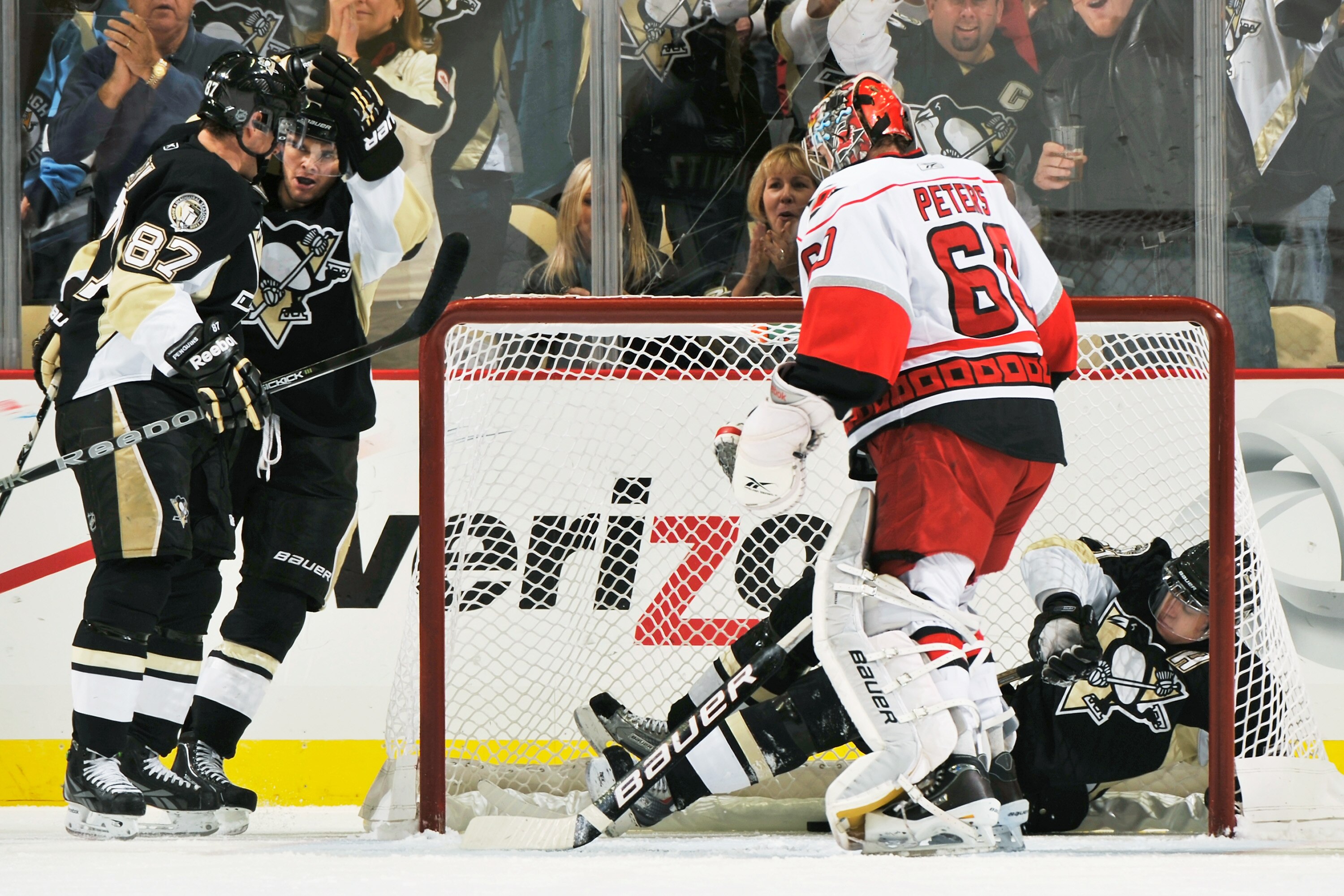 PITTSBURGH - NOVEMBER 19:  Sidney Crosby #87 of the Pittsburgh Penguins and Chris Kunitz #14 of the Pittsburgh Penguins celebrate Kunitz's goal on goaltender Justin Peters #60 of the Carolina Hurricanes as Evgeni Malkin #71 of the Pittsburgh Penguins clim