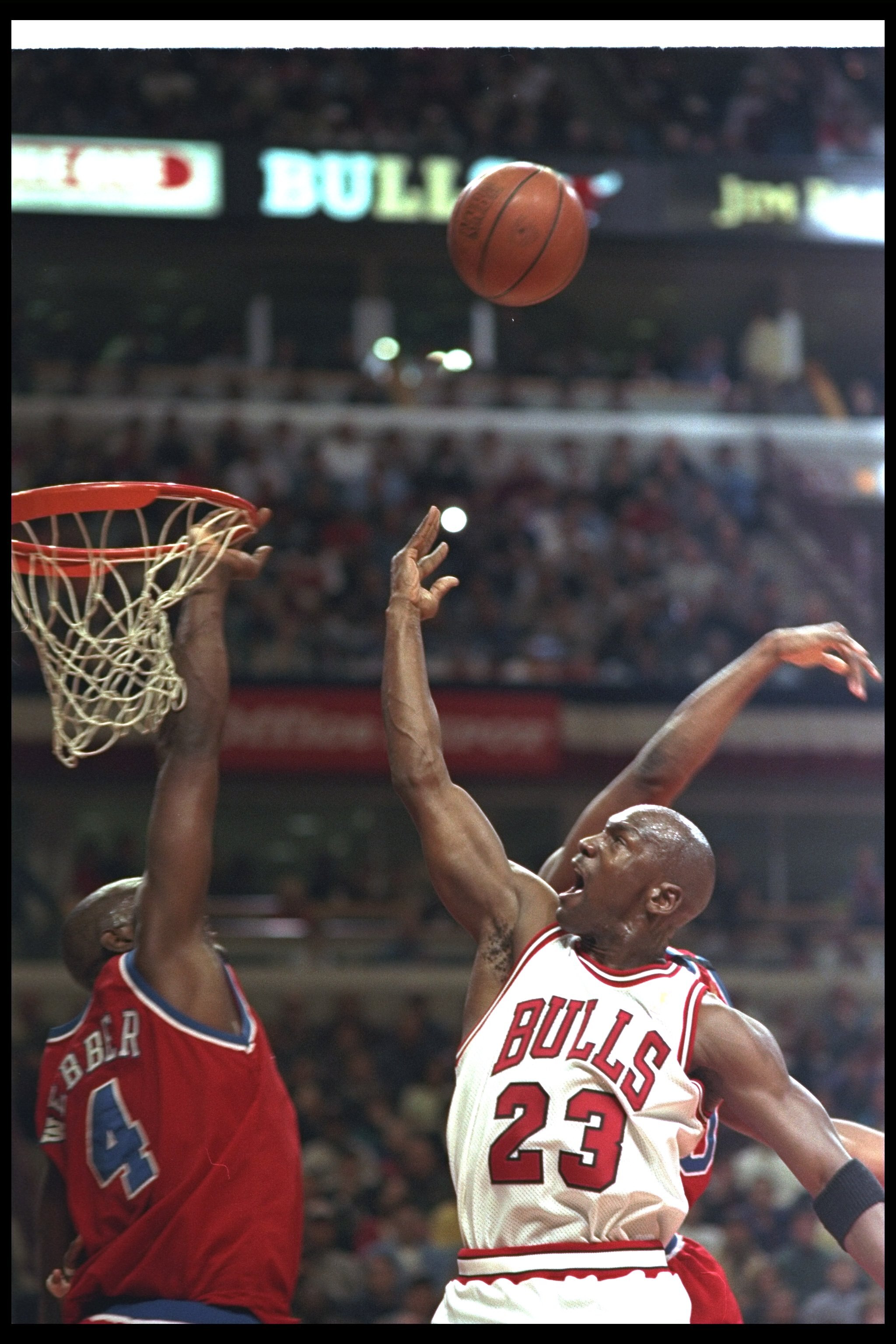 27 Apr 1997:  Michael Jordan of the Chicago Bulls tries to get the ball in as Chris Webber of the Washington Bullets knocks it out during the first round of the NBA Playoffs at United Center in Chicago, Illinois. The Bulls won 109-104.  Mandatory Credit: