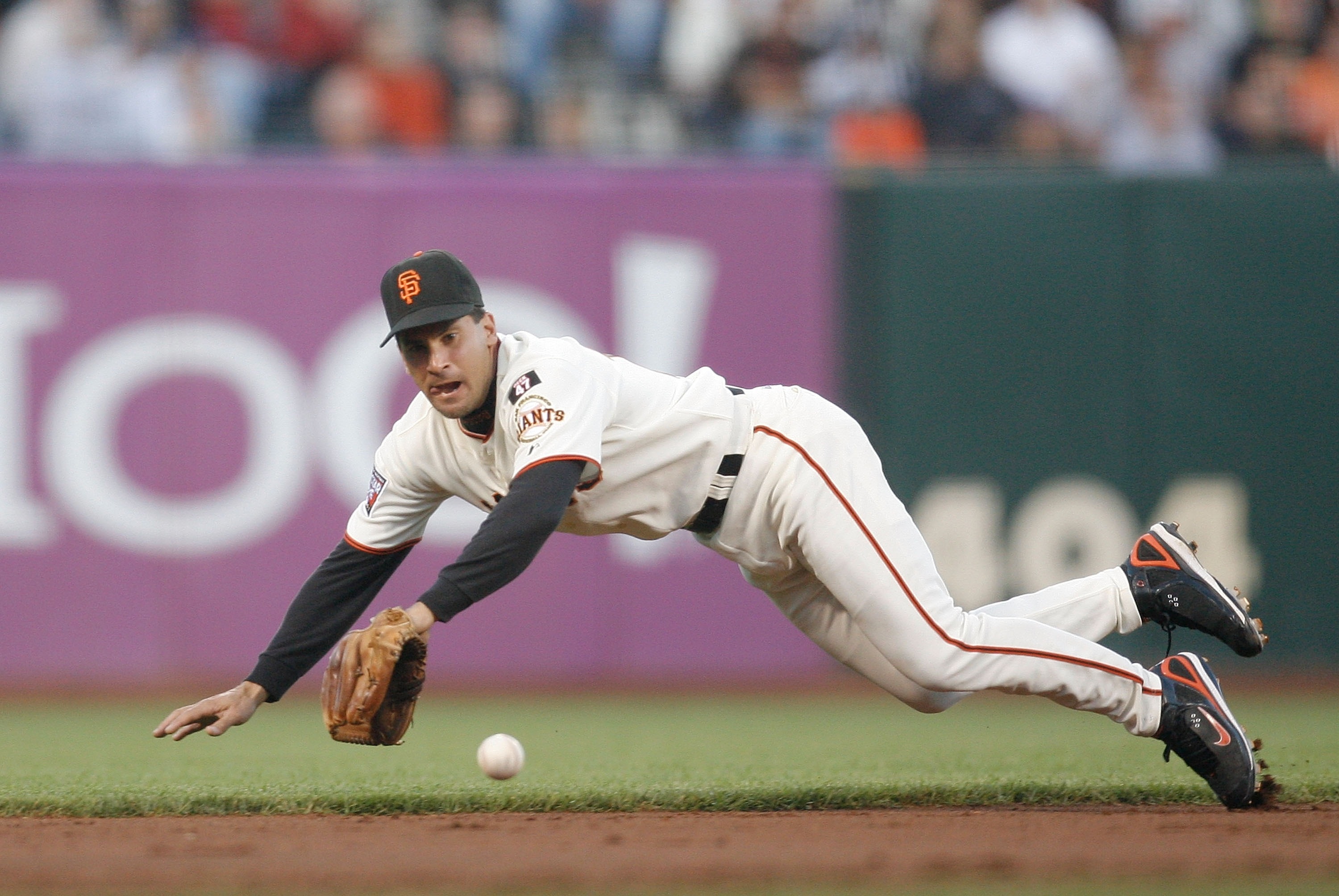 SAN FRANCISCO - AUGUST 21: Shortstop Omar Vizquel #13 of the San Francisco Giants dives for a groundball against the Chicago Cubs during a Major League Baseball game at AT&T Park on August 21, 2007 in San Francisco, California.  (Photo by Greg Trott/Getty