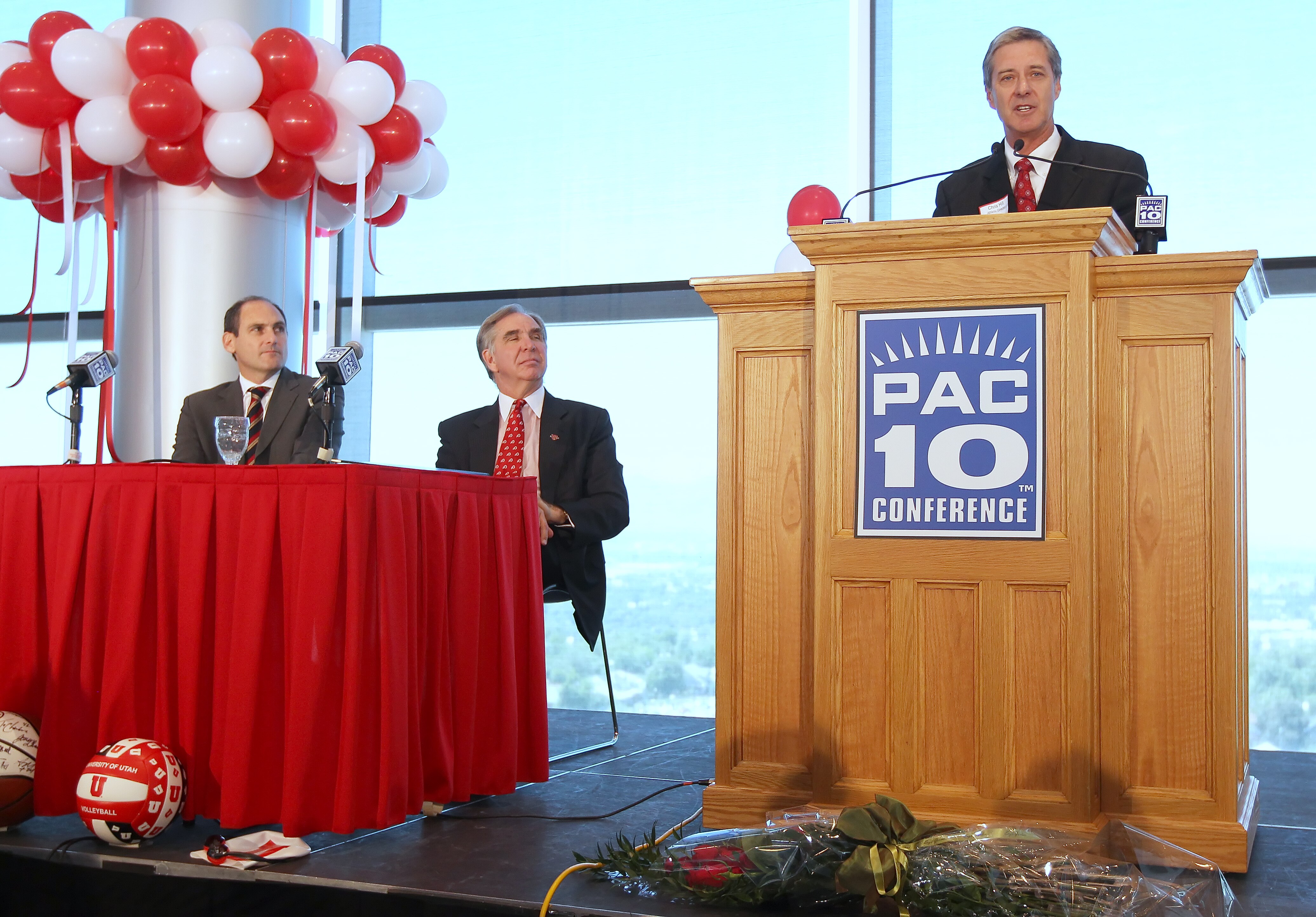 SALT LAKE CITY, UT - JUNE 17: Utah Athletic Director Dr. Chris Hill (R) talks as PAC-10 Commissioner Larry Scott (L) and President of the University of Utah Michael Young (C) listen as the University was admitted into the PAC-10 June 17, 2010 in Salt Lake