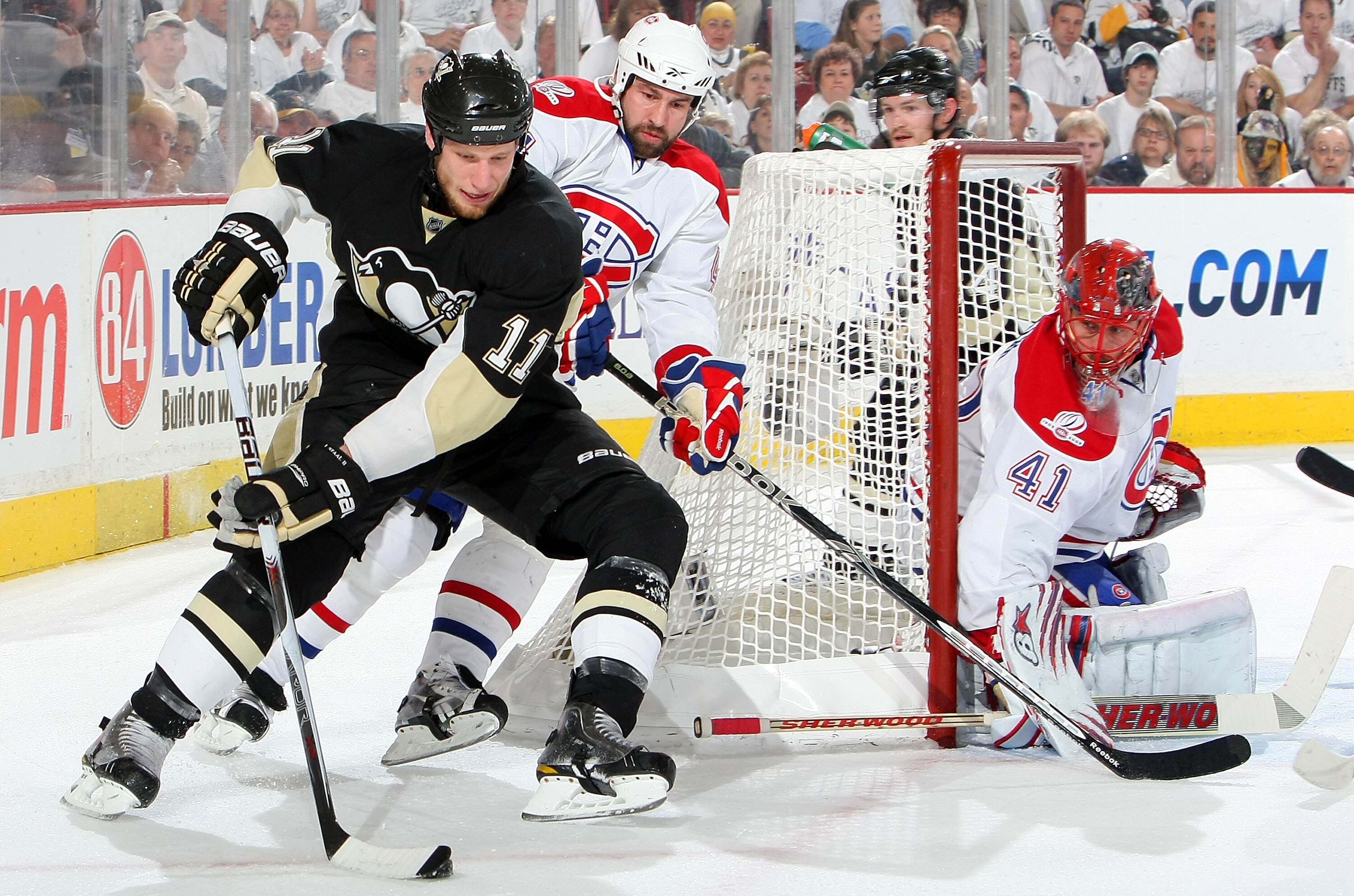 PITTSBURGH - MAY 12:  Jordan Staal #11 of the Pittsburgh Penguins attempts a wrap around on Jaroslav Halak #41 of the Montreal Canadiens as Roman Hamrlik #44 of the Canadiens defends in Game Seven of the Eastern Conference Semifinals during the 2010 Stanl
