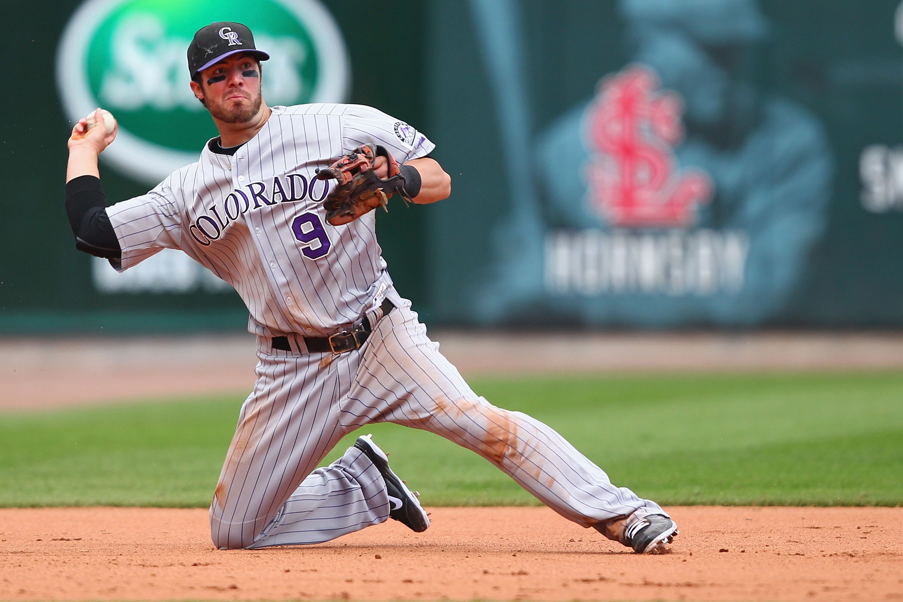 ST. LOUIS - OCTOBER 2: Ian Stewart #9 of the Colorado Rockies throws to first base against the St. Louis Cardinals at Busch Stadium on October 2, 2010 in St. Louis, Missouri.  The Cardinals beat the Rockies 1-0 in 11 innings.  (Photo by Dilip Vishwanat/Ge