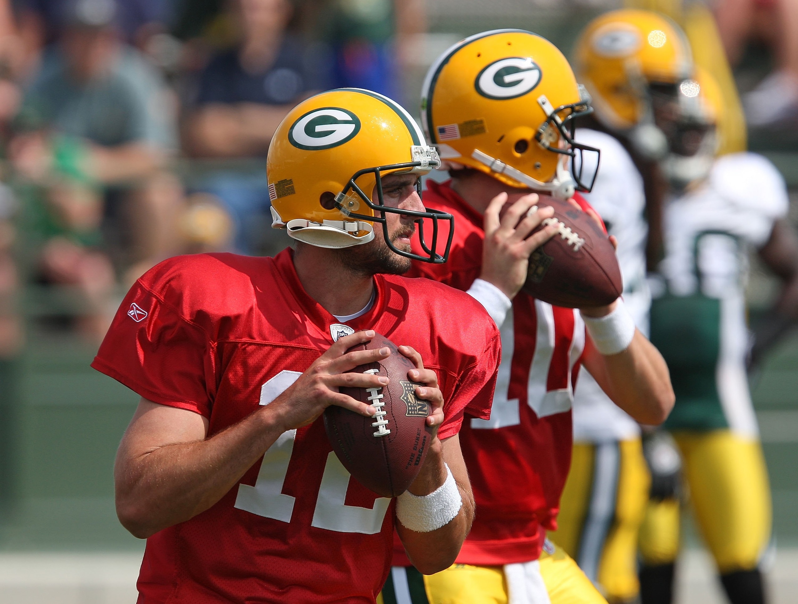 GREEN BAY, WI - AUGUST 03: Aaron Rodgers #12 and Matt Flynn #10 of the Green Bay Packers drop back to pass during practice at summer training camp on August 3, 2009 at the Ray Nitschke Field in Green Bay, Wisconsin. (Photo by Jonathan Daniel/Getty Images) GREEN BAY, WI - AUGUST 03: Aaron Rodgers #12 and Matt Flynn #10 of the Green Bay Packers drop back to pass during practice at summer training camp on August 3, 2009 at the Ray Nitschke Field in Green Bay, Wisconsin. (Photo by Jonathan Daniel/Getty Images)