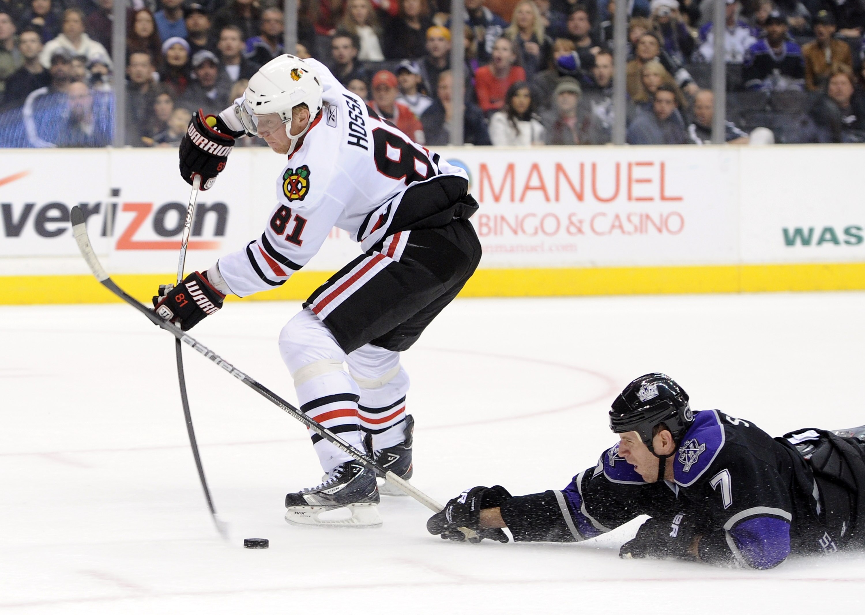 LOS ANGELES, CA - NOVEMBER 27:  Marian Hossa #81 of the Chicago Blackhawks has the puck knocked away on his breakaway by a diving Rob Scuderi #7 of the Los Angeles Kings during the first period at Staples Center on November 27, 2010 in Los Angeles, Califo