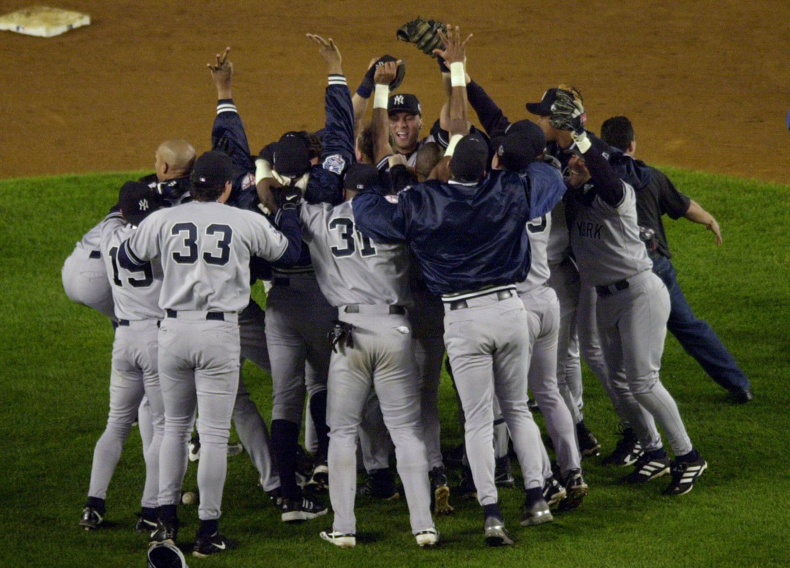 26 Oct 2000:  The New York Yankees mob pitcher Mariano Rivera after the last out is made against the New York Mets in Game 5 of the World Series at Shea Stadium in Flushing, New York. DIGITAL IMAGE> Mandatory Credit: Matthew Stockman/ALLSPORT