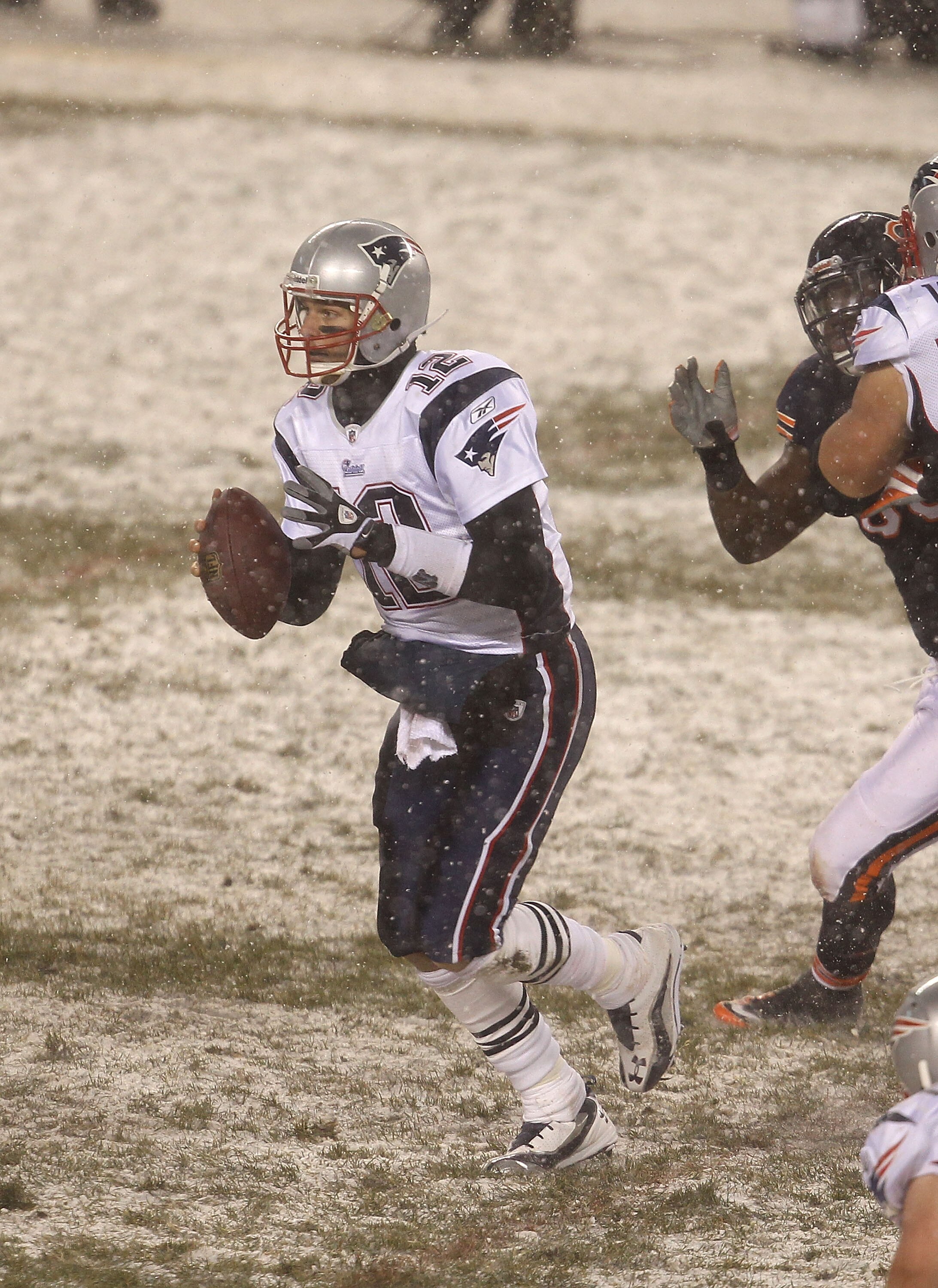 CHICAGO, IL - DECEMBER 12: Tom Brady #12 of the New England Patriots looks for a receiver against the Chicago Bears at Soldier Field on December 12, 2010 in Chicago, Illinois. The Patriots defeated the Bears 36-7. (Photo by Jonathan Daniel/Getty Images)