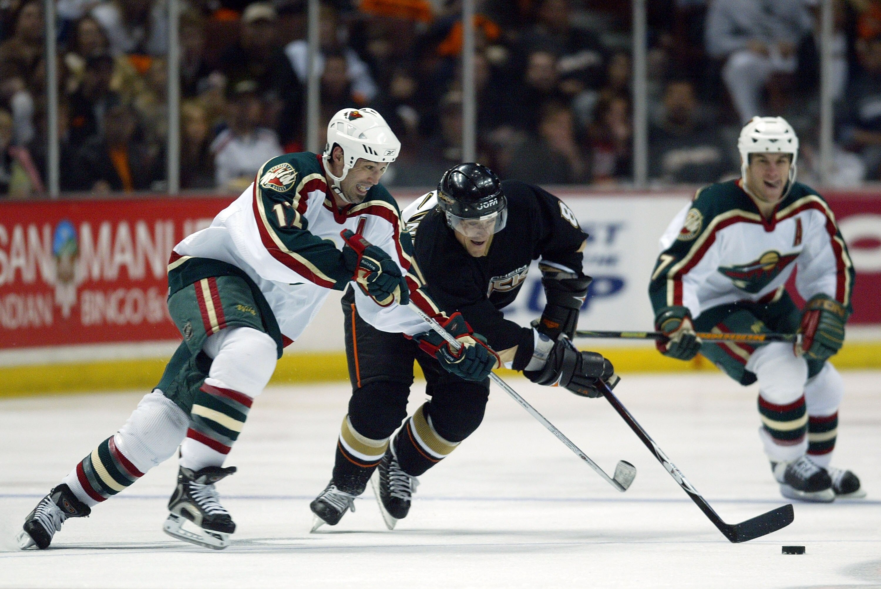 ANAHEIM, CA - APRIL 13:  Teemu Selanne #8 of the Anaheim Ducks skates with the puck against Brian Rolston #12 of the Minnesota Wild in the second period during game two of the 2007 Western Conference Quarterfinals at Honda Center on April 13, 2007 in Anah
