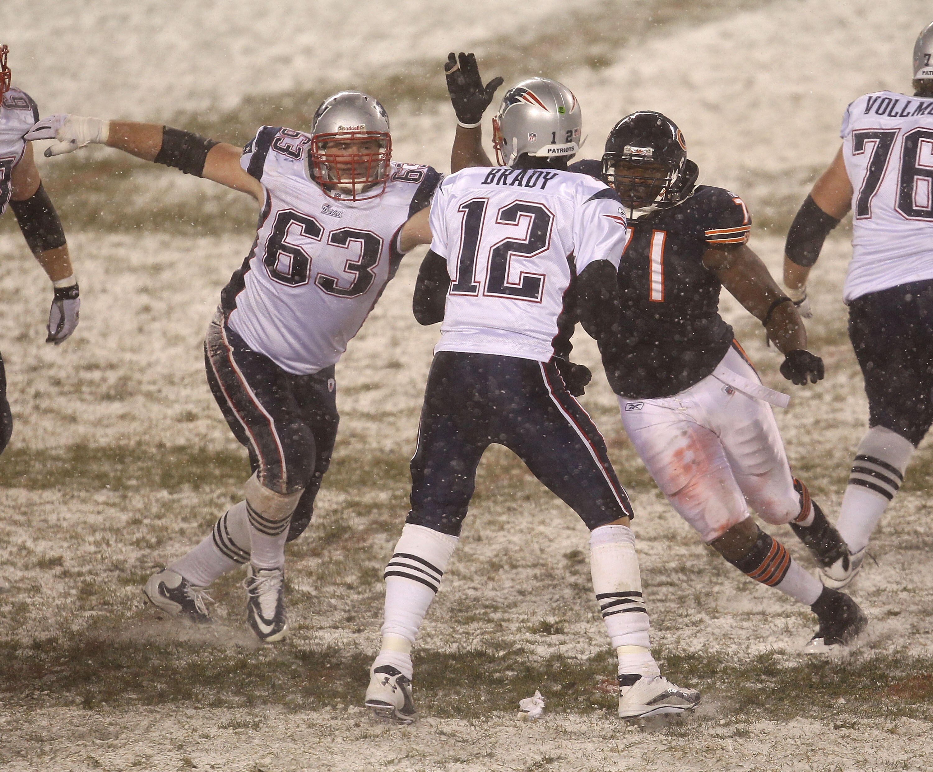 CHICAGO - DECEMBER 12: Israel Idonije #71 of the Chicago Bears rushes past Dan Connolly #63 of the New England Patriots towards Tom Brady #12 at Soldier Field on December 12, 2010 in Chicago, Illinois. The Patriots defeated the Bears 36-7. (Photo by Jonat