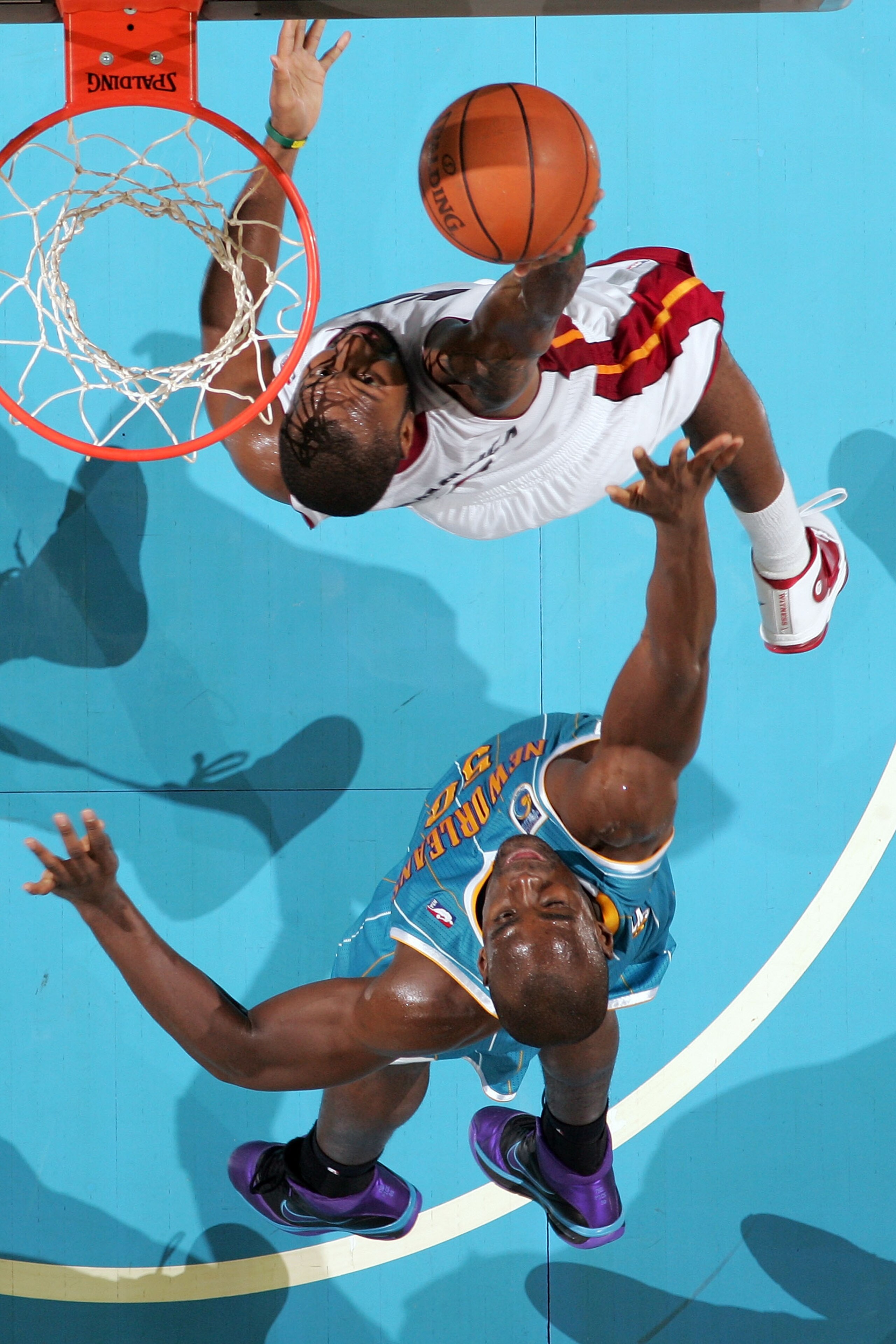 NEW ORLEANS - OCTOBER 13: Kenny Hasbrouck #4 of the Miami Heat grabs a rebound over Emeka Okafor #50 of the New Orleans Hornets at the New Orleans Arena on October 13, 2010 in New Orleans, Louisiana. NOTE TO USER: User expressly acknowledges and agrees NEW ORLEANS - OCTOBER 13: Kenny Hasbrouck #4 of the Miami Heat grabs a rebound over Emeka Okafor #50 of the New Orleans Hornets at the New Orleans Arena on October 13, 2010 in New Orleans, Louisiana. NOTE TO USER: User expressly acknowledges and agrees