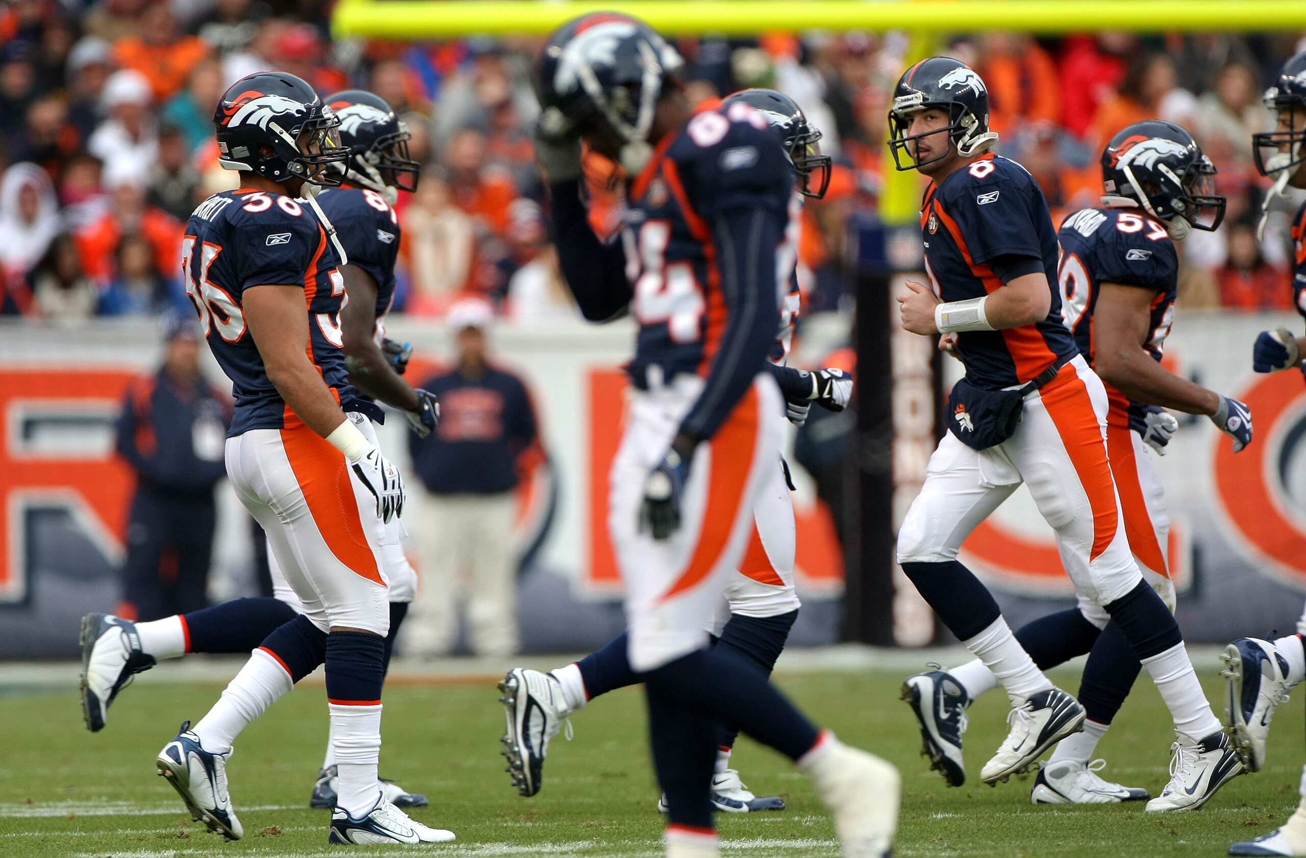 DENVER - JANUARY 03: Quarterback Kyle Orton #8 of the Denver Broncos and the offense head for the bench as the punting squad enters the field against the Kansas City Chiefs during NFL action at Invesco Field at Mile High on January 3, 2010 in Denver, Colo