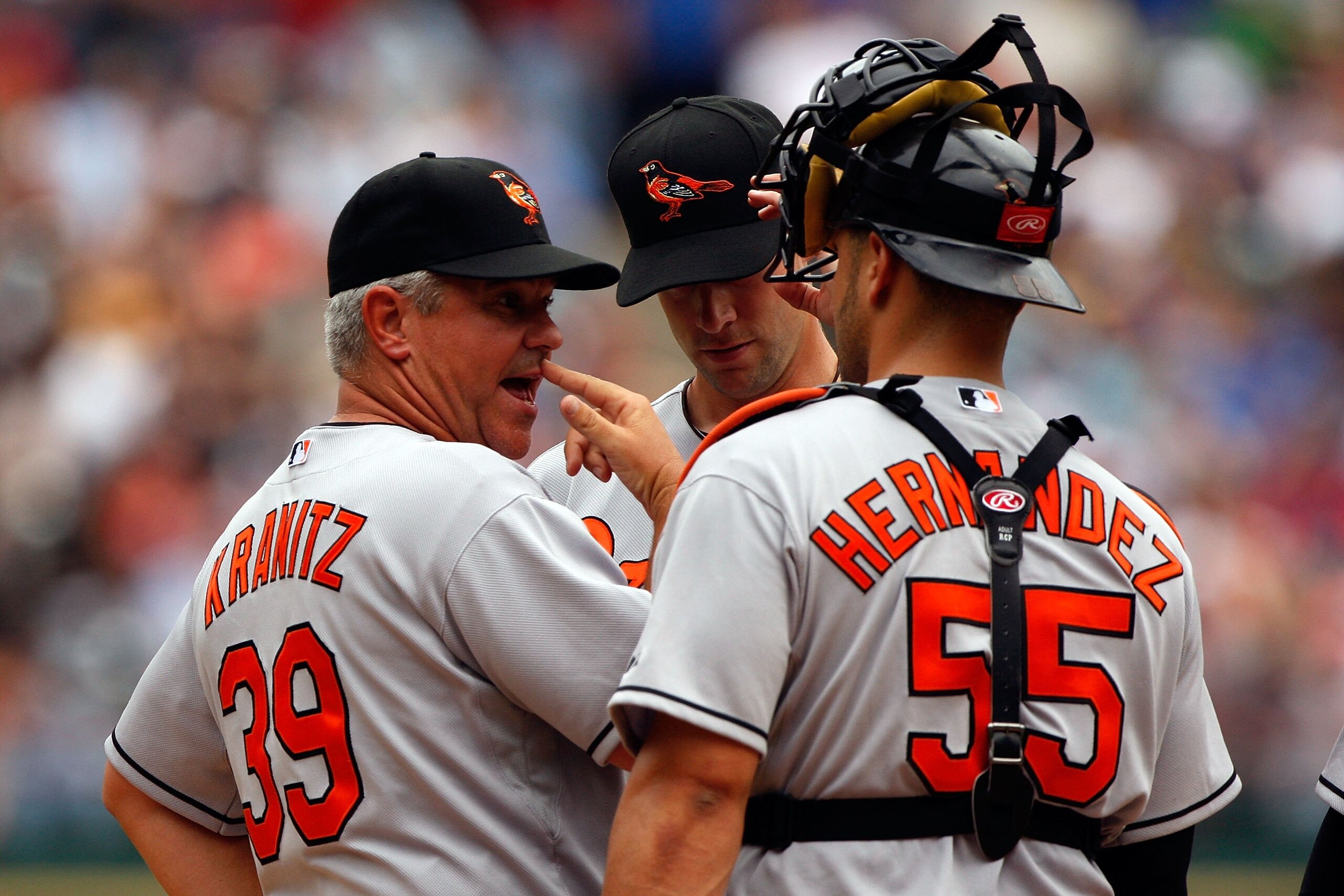 ARLINGTON, TX - APRIL 08:  Rick Kranitz #39, Pitcher Brian Burres #56 and catcher Ramon Hernandez #55 of the Baltimore Orioles speak at the pitchers mound against the Texas Rangers on April 8, 2008 at Rangers Ballpark in Arlington, Texas  (Photo by Chris