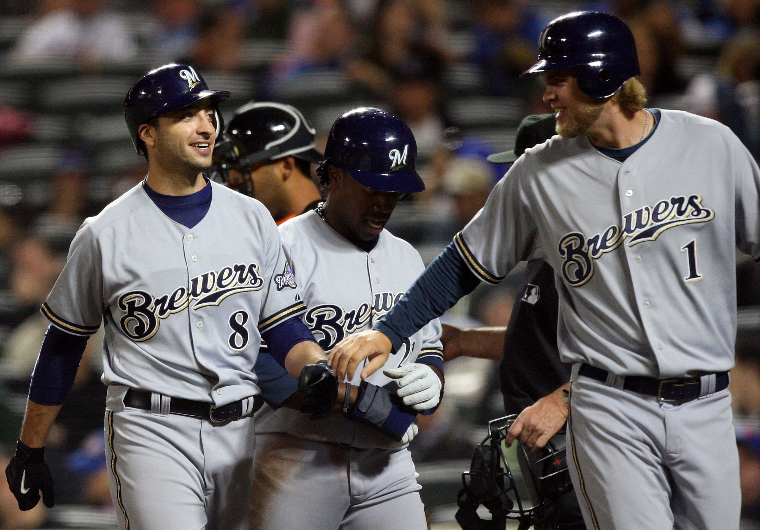 NEW YORK - APRIL 17:  Ryan Braun #8 of the Milwaukee Brewers celebrates his sixth inning three run home run against the New York Mets with teammates Rickie Weeks #23 and Corey Hart #1 on April 17, 2009 at Citi Field in the Flushing neighborhood of the Que