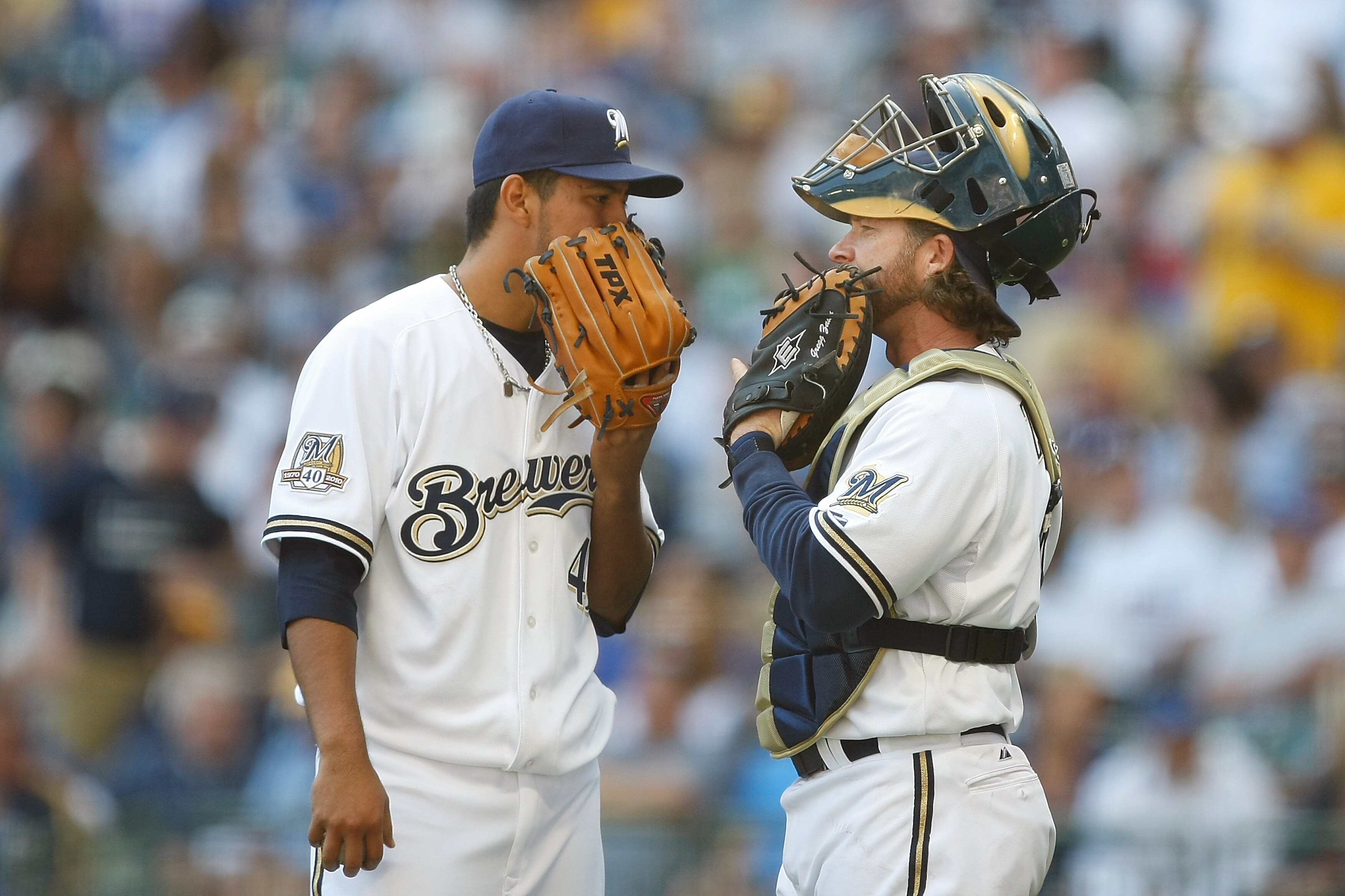 MILWAUKEE, WI - APRIL 05: Pitcher Yovani Gallardo #49 of the Milwaukee Brewers talks with catcher Gregg Zaun #9 against the Colorado Rockies at the Miller Park on April 05, 2010 in Milwaukee, Wisconsin. The Rockies defeated the Brewers 5-3.(Photo by Scott