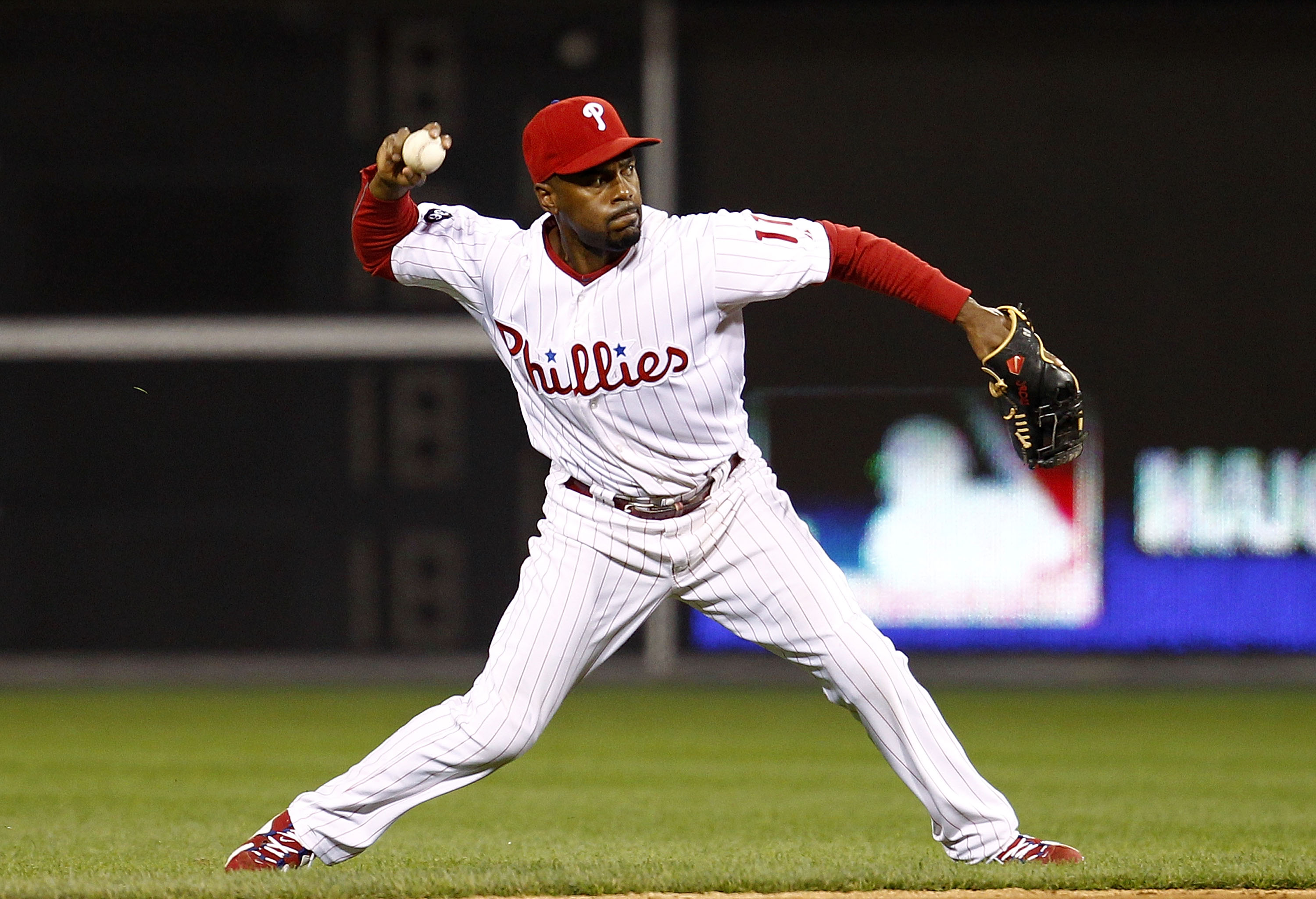 PHILADELPHIA - OCTOBER 08:  Jimmy Rollins #11 of the Philadelphia Phillies throws to first base in Game 2 of the NLDS against the Cincinnati Reds at Citizens Bank Park on October 8, 2010 in Philadelphia, Pennsylvania.  (Photo by Jeff Zelevansky/Getty Imag