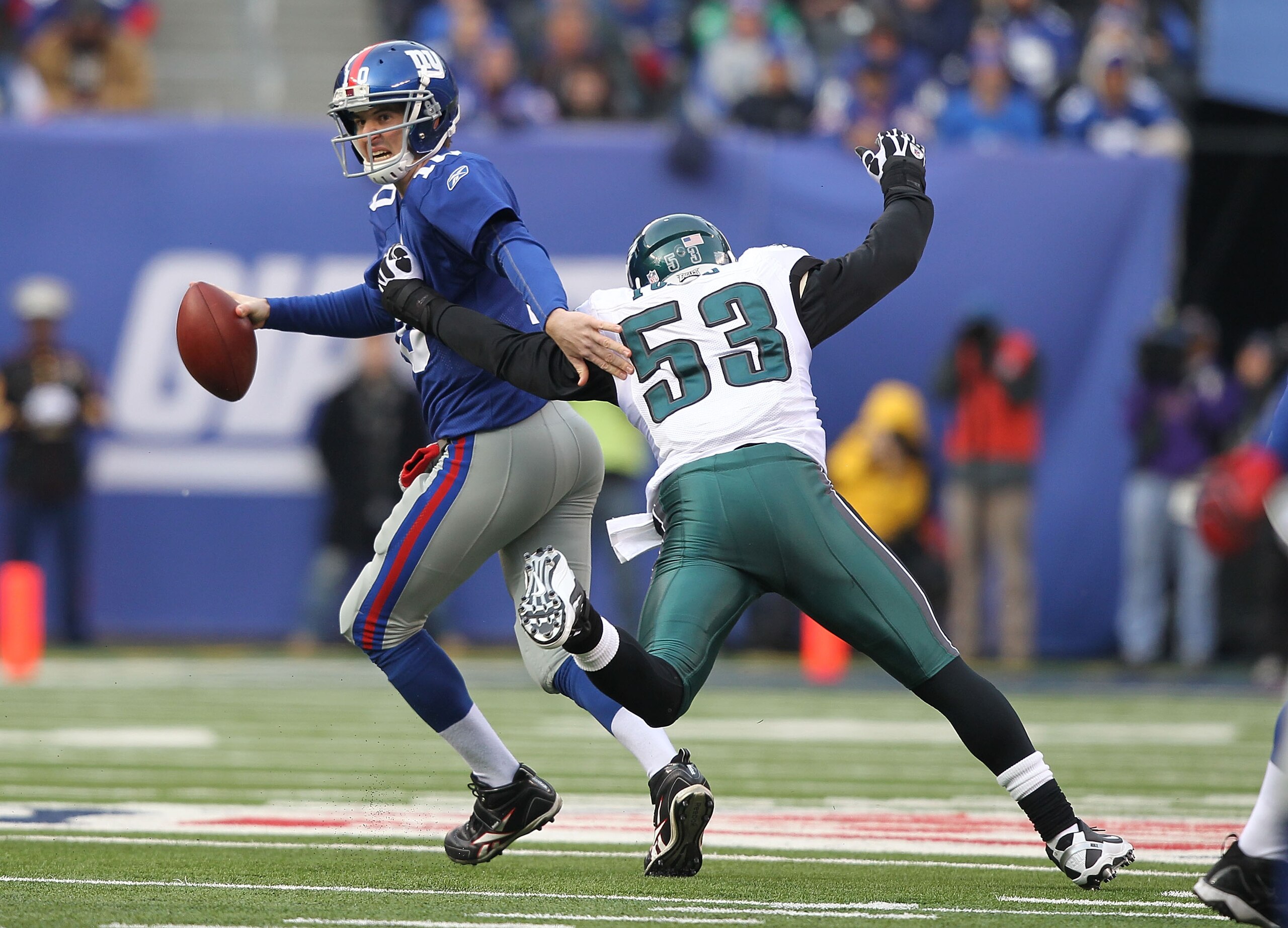 EAST RUTHERFORD, NJ - DECEMBER 19:  Eli Manning #10 of the New York Giants is sacked by Moise Fokou #53 of the Philadelphia Eagles during their game on December 19, 2010 at The New Meadowlands Stadium in East Rutherford, New Jersey.  (Photo by Al Bello/Ge