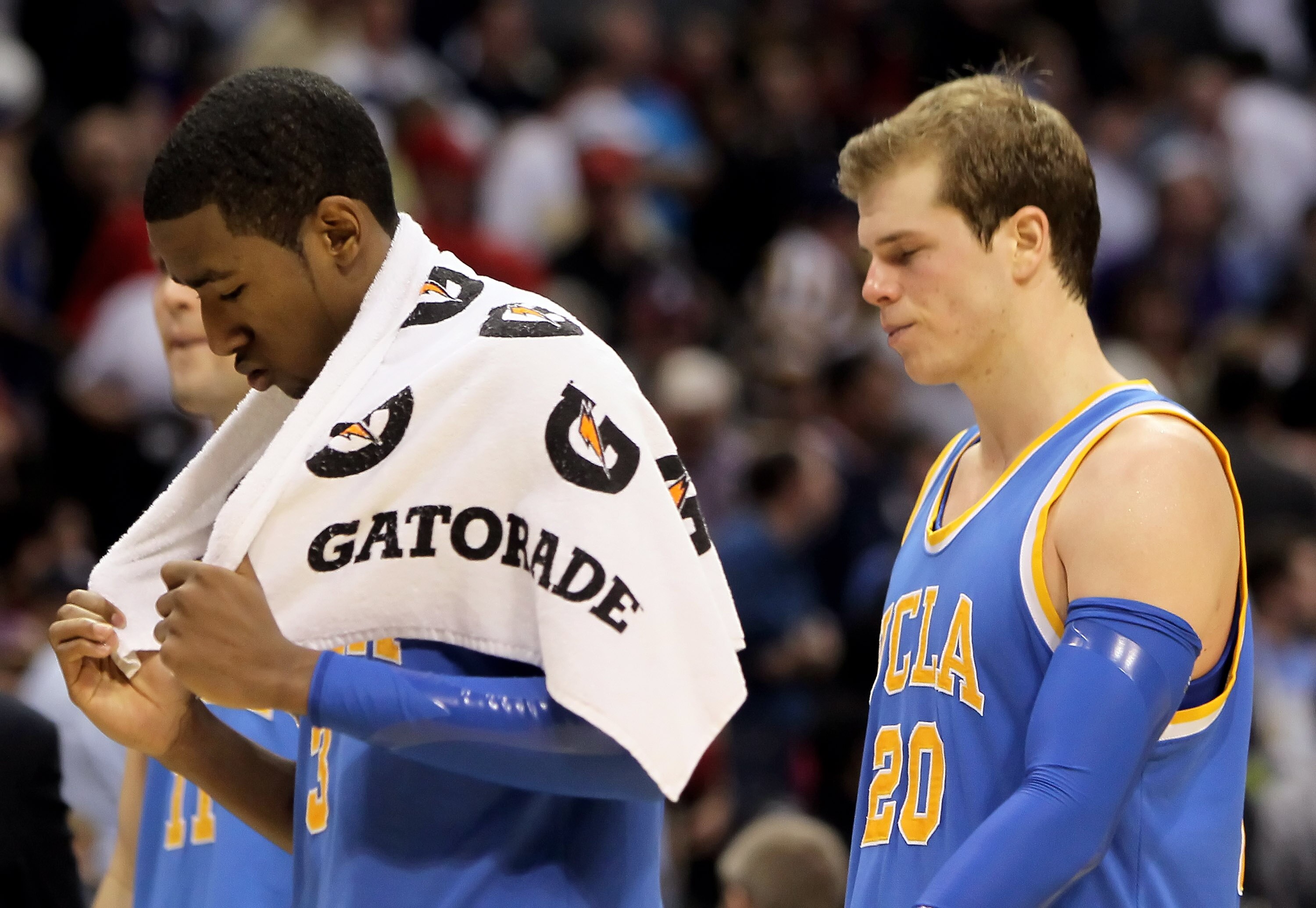 LOS ANGELES, CA - MARCH 12:  Malcolm Lee #3 and Michael Roll #20 of the UCLA Bruins walk off the court following their loss to the Cal Golden Bears during the Semifinals of the Pac-10 Basketball Tournament at Staples Center on March 12, 2010 in Los Angele