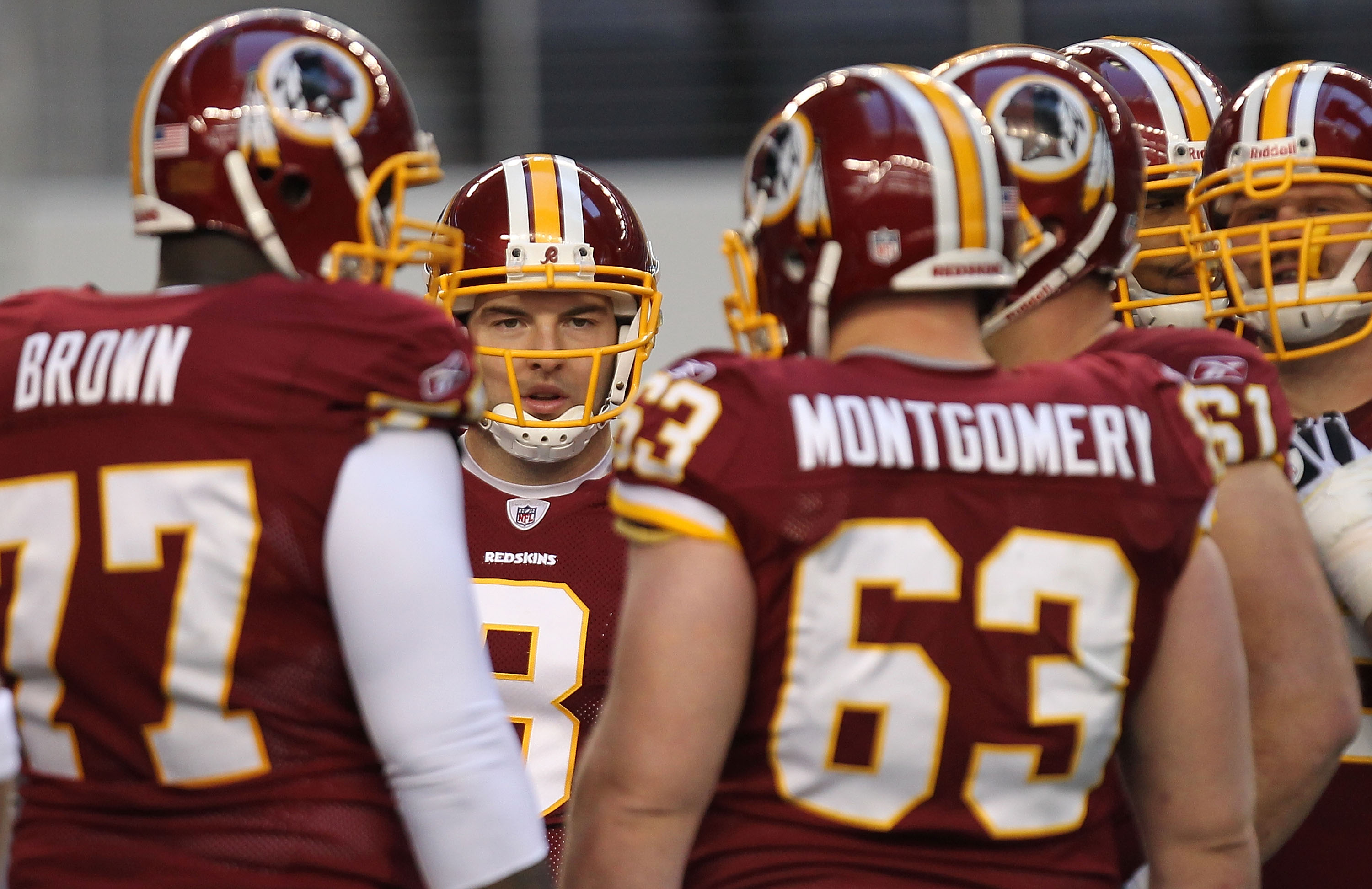 ARLINGTON, TX - DECEMBER 19:  Quarterback Rex Grossman #8 of the Washington Redskins huddles the offense against the Dallas Cowboys in the first quarter at Cowboys Stadium on December 19, 2010 in Arlington, Texas.  (Photo by Ronald Martinez/Getty Images)