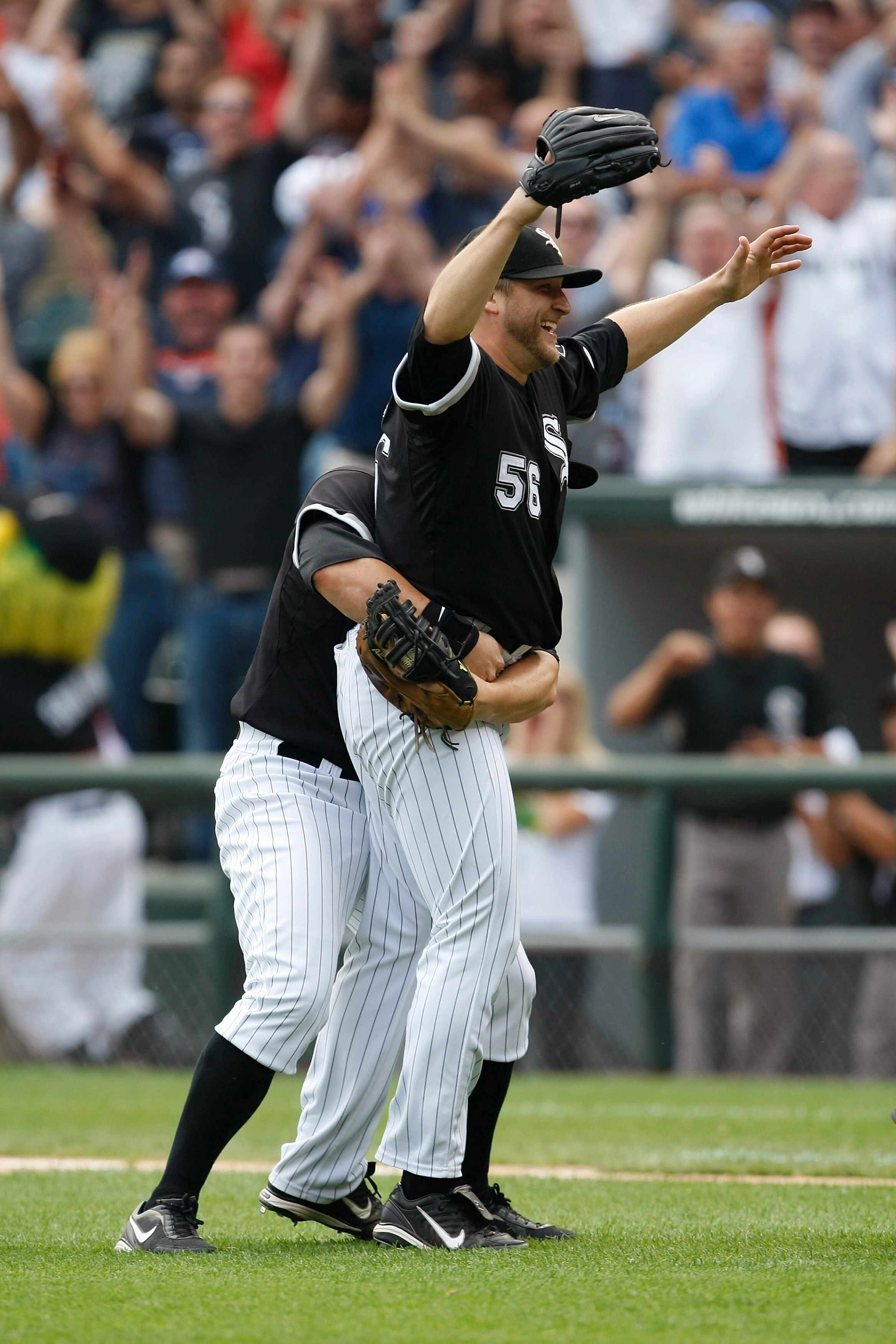 CHICAGO, IL - JULY 23: Pitcher Mark Buehrle #56 of the Chicago White Sox celebrates after pitching a perfect game as he is grabbed by first baseman Josh Fields #7 against the Tampa Bay Rays at U.S. Cellular Field on July 23, 2009 in Chicago, Illinois. The