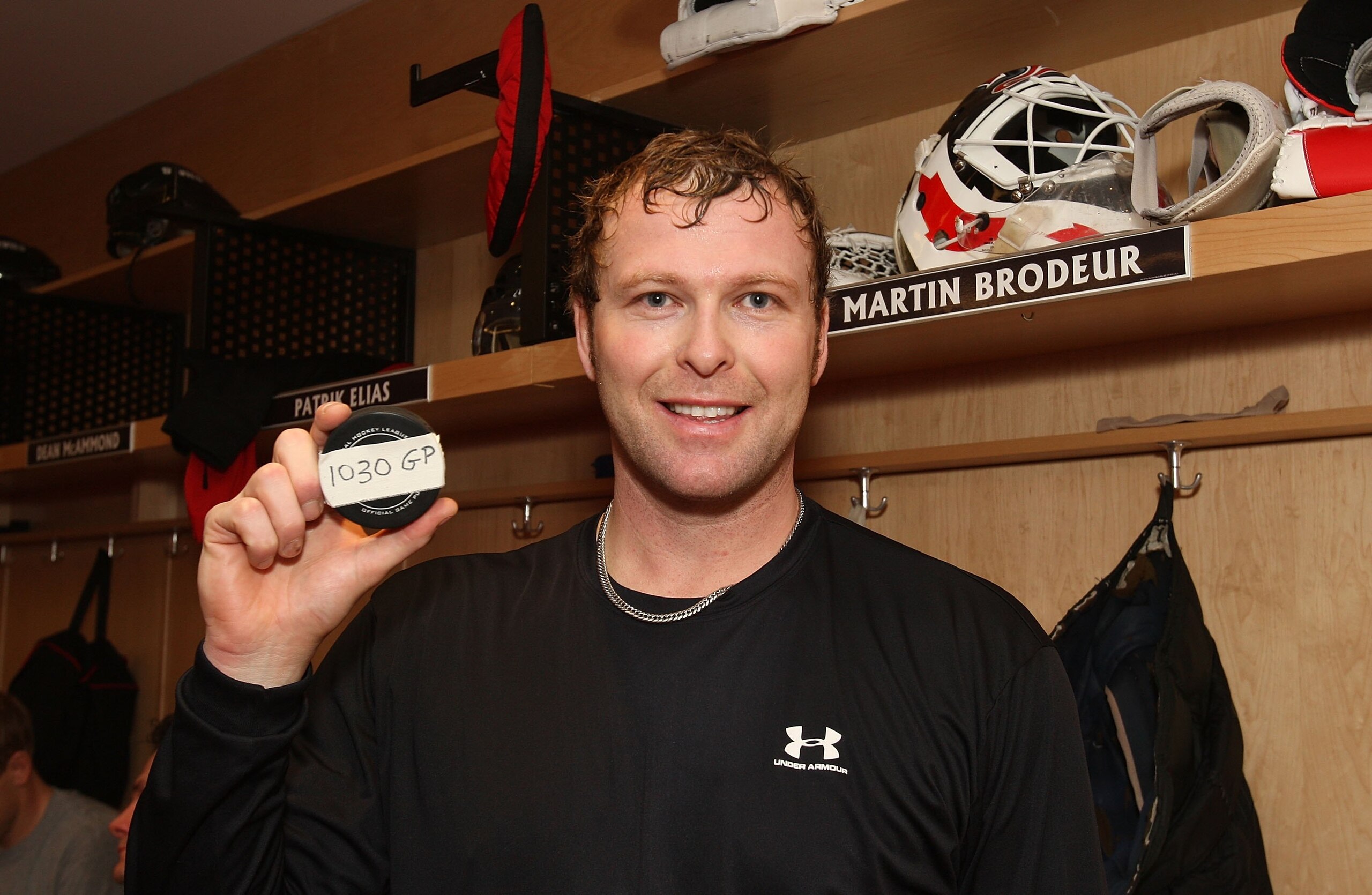 NEWARK, NJ - DECEMBER 18: Martin Brodeur #30 of the New Jersey Devils holds the game puck after appearing in his NHL record breaking 1030th NHL game against the Ottawa Senators at the Prudential Center on December 18, 2009 in Newark, New Jersey. The Devil