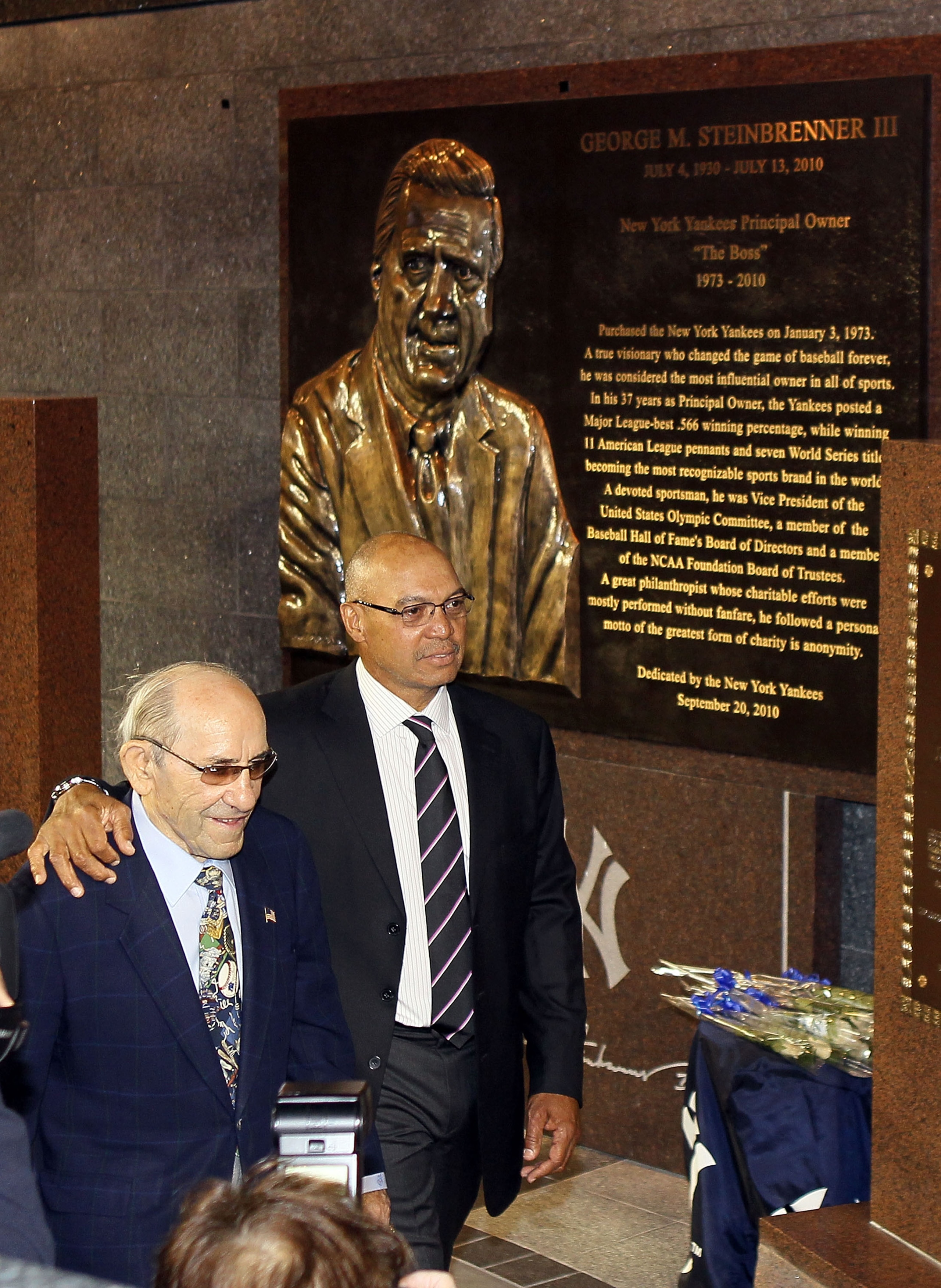 NEW YORK - SEPTEMBER 20:  New York Yankees Hall of Famers Yogi Berra (L) and Reggie Jackson walk past the monument to the late owner George Steinbrenner prior to a game against the Tampa Bay Rays on September 20, 2010 at Yankee Stadium in the Bronx boroug