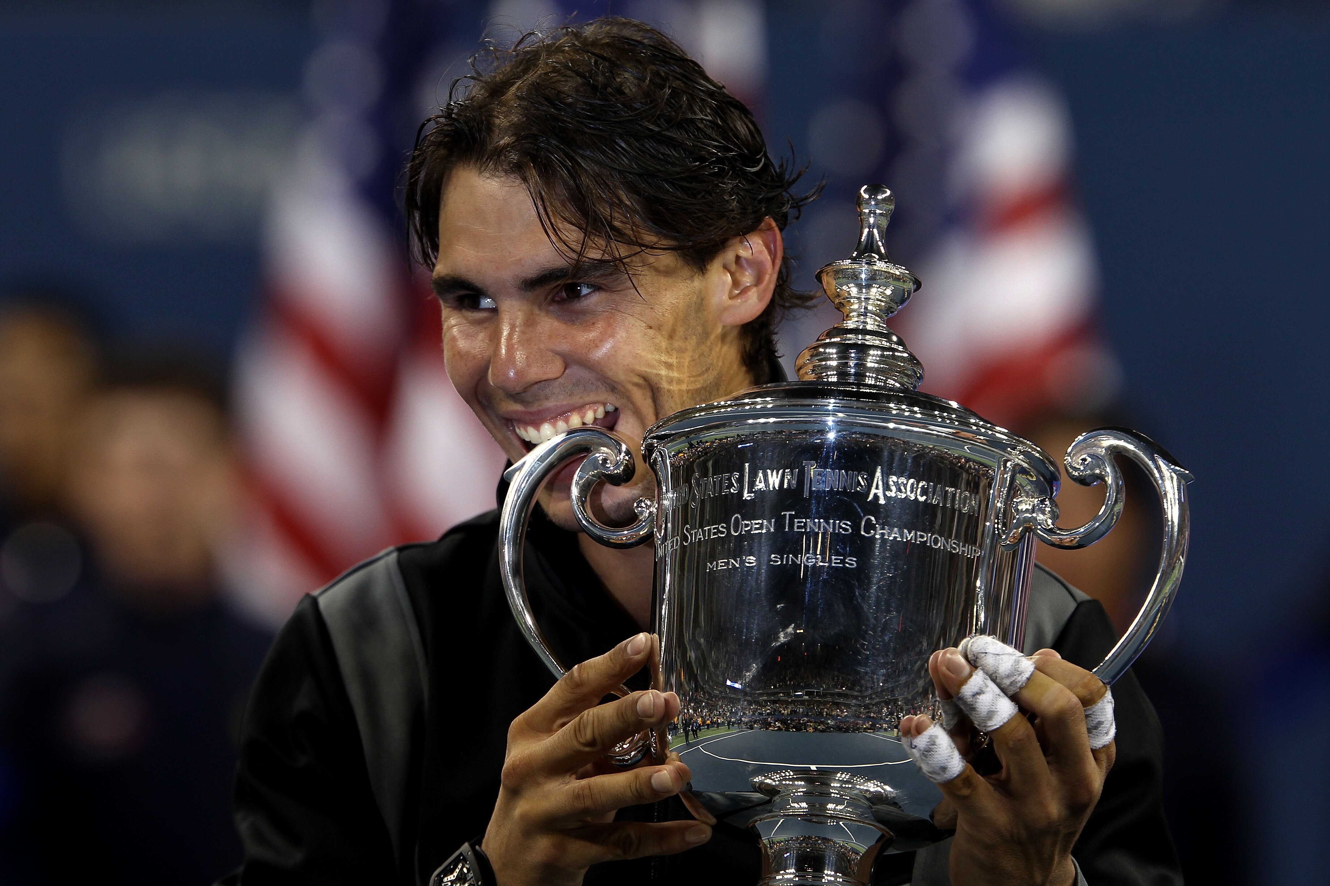 NEW YORK - SEPTEMBER 13:  Rafael Nadal of Spain bites the championship trophy during the trophy ceremony after defeating Novak Djokovic of Serbia to win the men's singles final on day fifteen of the 2010 U.S. Open at the USTA Billie Jean King National Ten