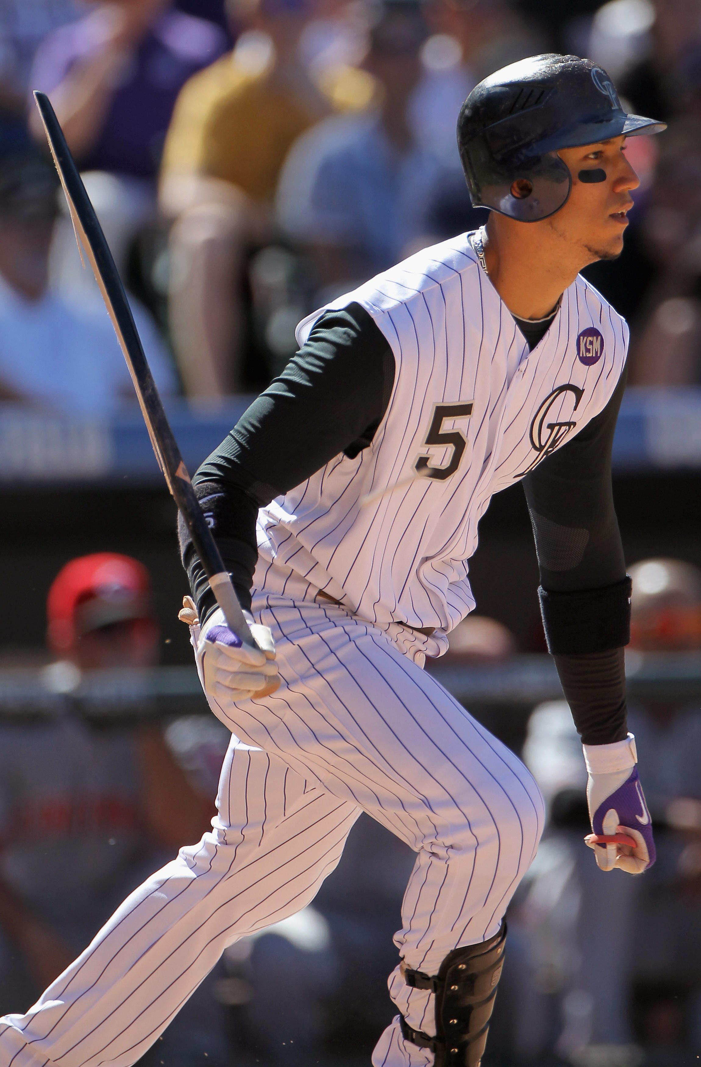 DENVER - SEPTEMBER 06:  Carlos Gonzalez #5 of the Colorado Rockies follows through as he breaks his bat against the Cincinnati Reds at Coors Field on September 6, 2010 in Denver, Colorado. The Rockies defeated the Reds 10-5.  (Photo by Doug Pensinger/Gett