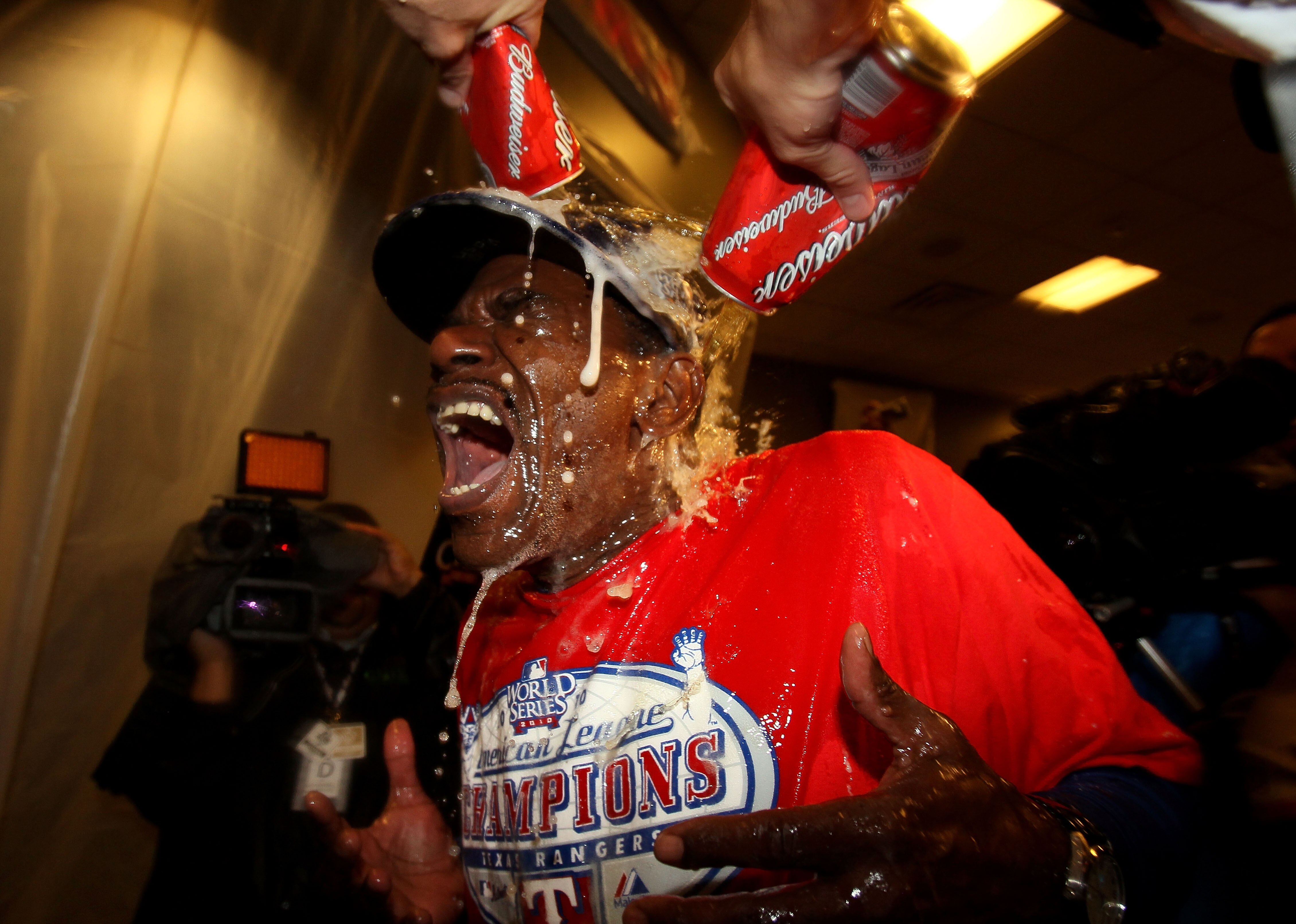 ARLINGTON, TX - OCTOBER 22:  Manager Ron Washington of the Texas Rangers is doused with liquid in the lockerroom after defeating the New York Yankees 6-1 in Game Six of the ALCS to advance to the World Series during the 2010 MLB Playoffs at Rangers Ballpa