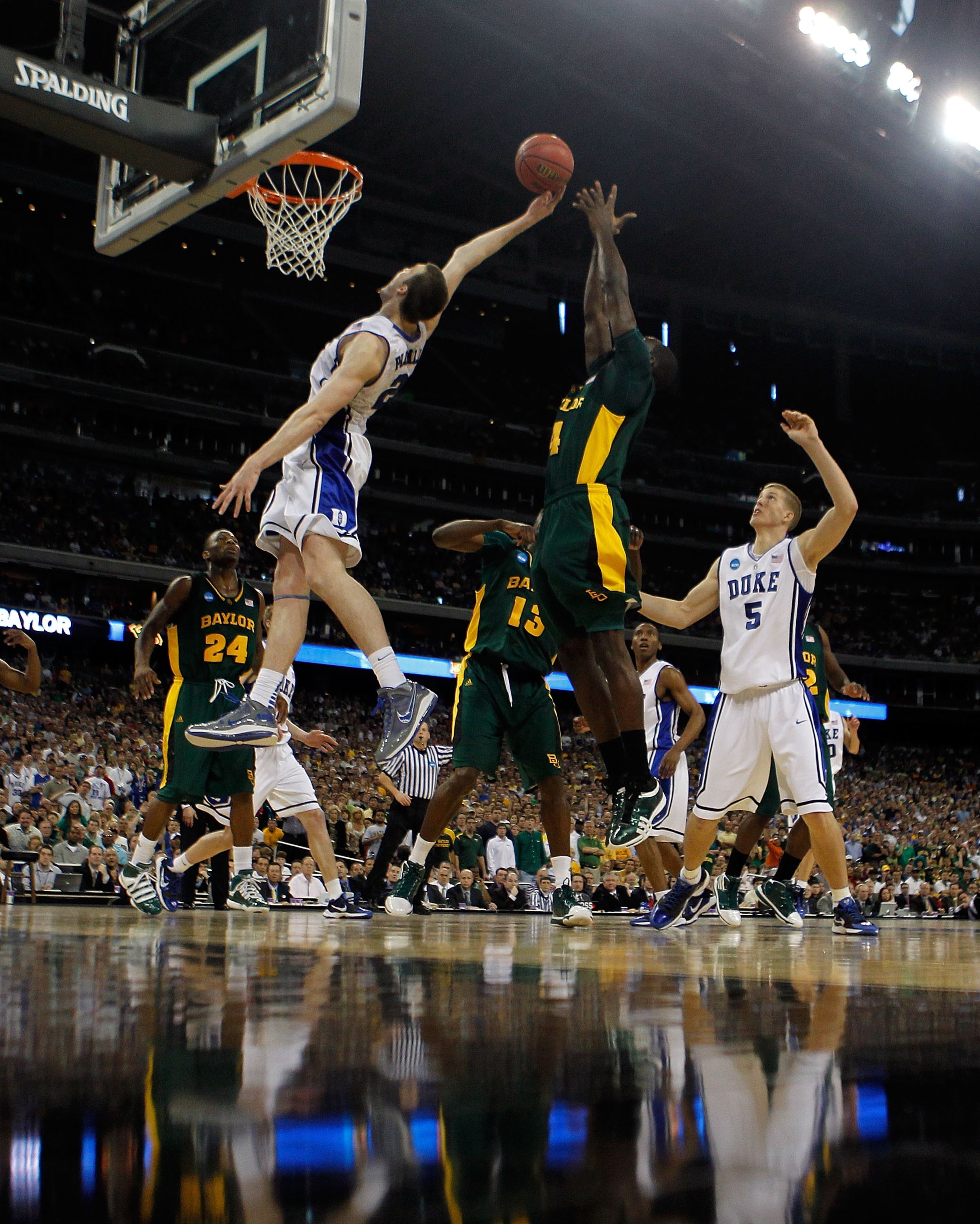 HOUSTON - MARCH 28: Miles Plumlee #21 of the Duke Dlue Devils leaps for a rebound in front of Quincy Acy #4 of the Baylor Bears during the south regional final of the 2010 NCAA men's basketball tournament at Reliant Stadium on March 28, 2010 in Houston, T
