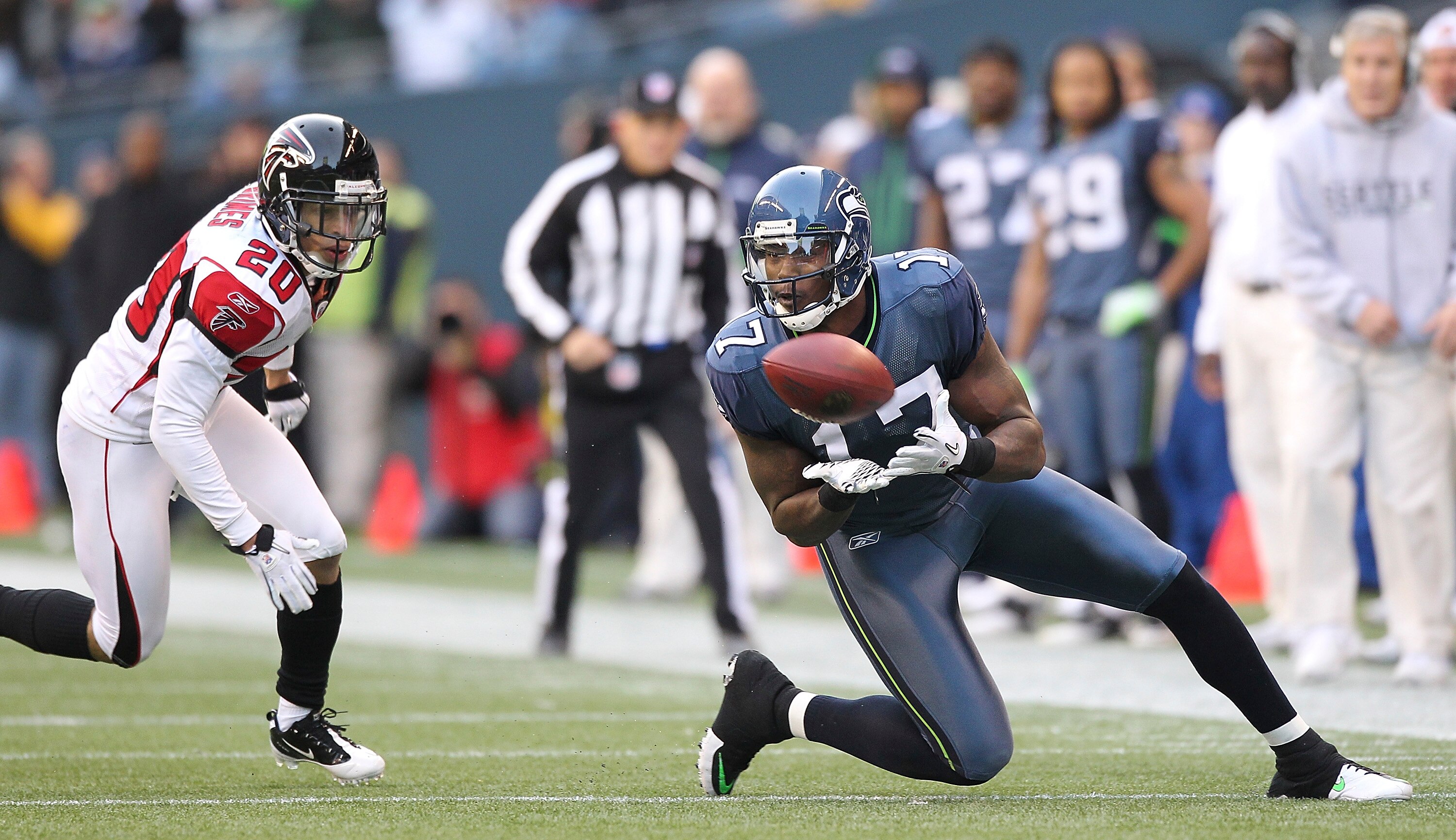 SEATTLE, WA - DECEMBER 19:  Wide receiver Mike Williams #17 of the Seattle Seahawks makes a catch against Brent Grimes #20 of the Atlanta Falcons at Qwest Field on December 19, 2010 in Seattle, Washington. The Falcons defeated the Seahawks 34-18. (Photo b