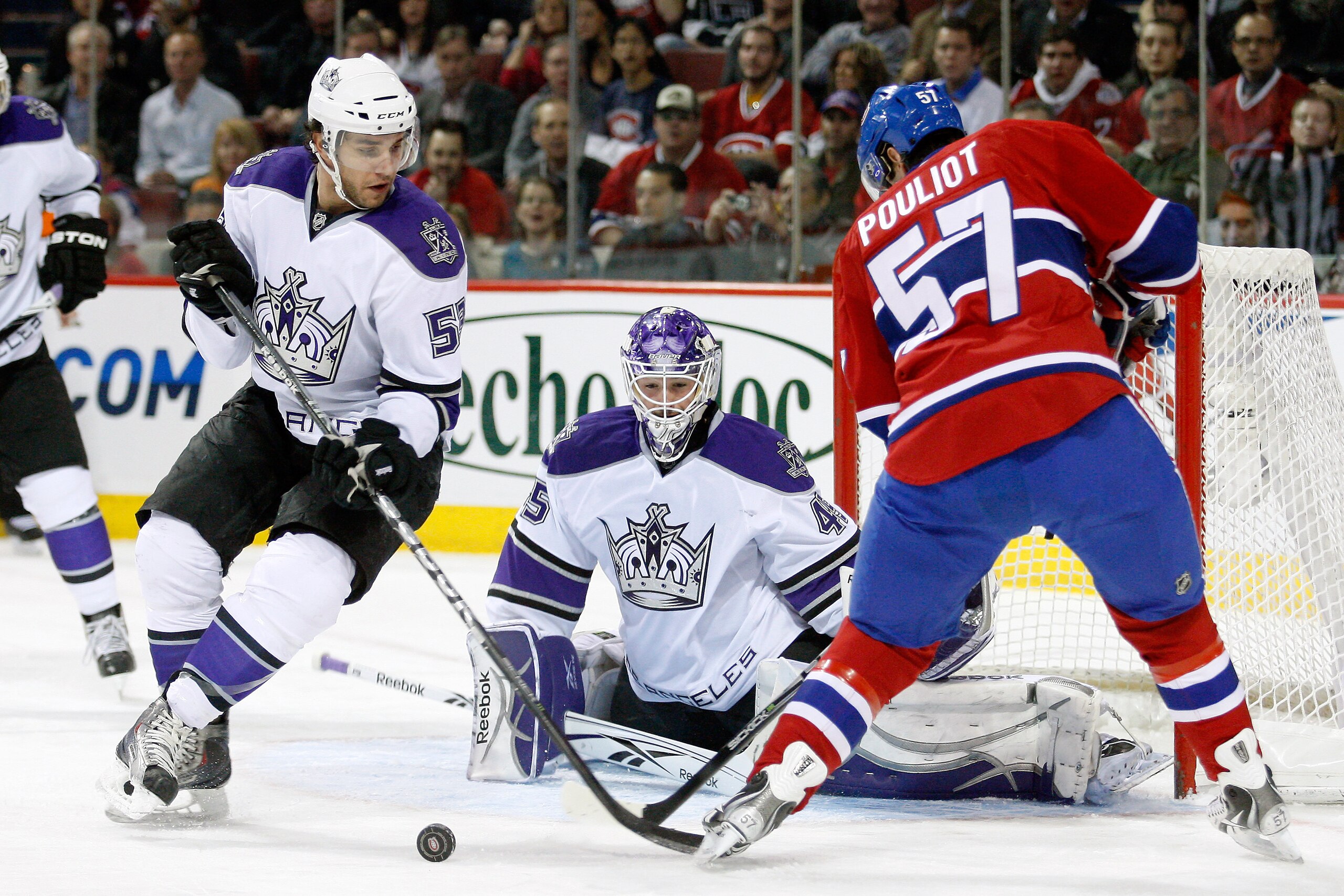 MONTREAL- NOVEMBER 24:  Benoit Pouliot #57 of the Montreal Canadiens fans on a shot in front of Jonathan Bernier #45 and Alec Martinez #53 of the Los Angeles Kings during the NHL game at the Bell Centre on November 24, 2010 in Montreal, Quebec, Canada.  (