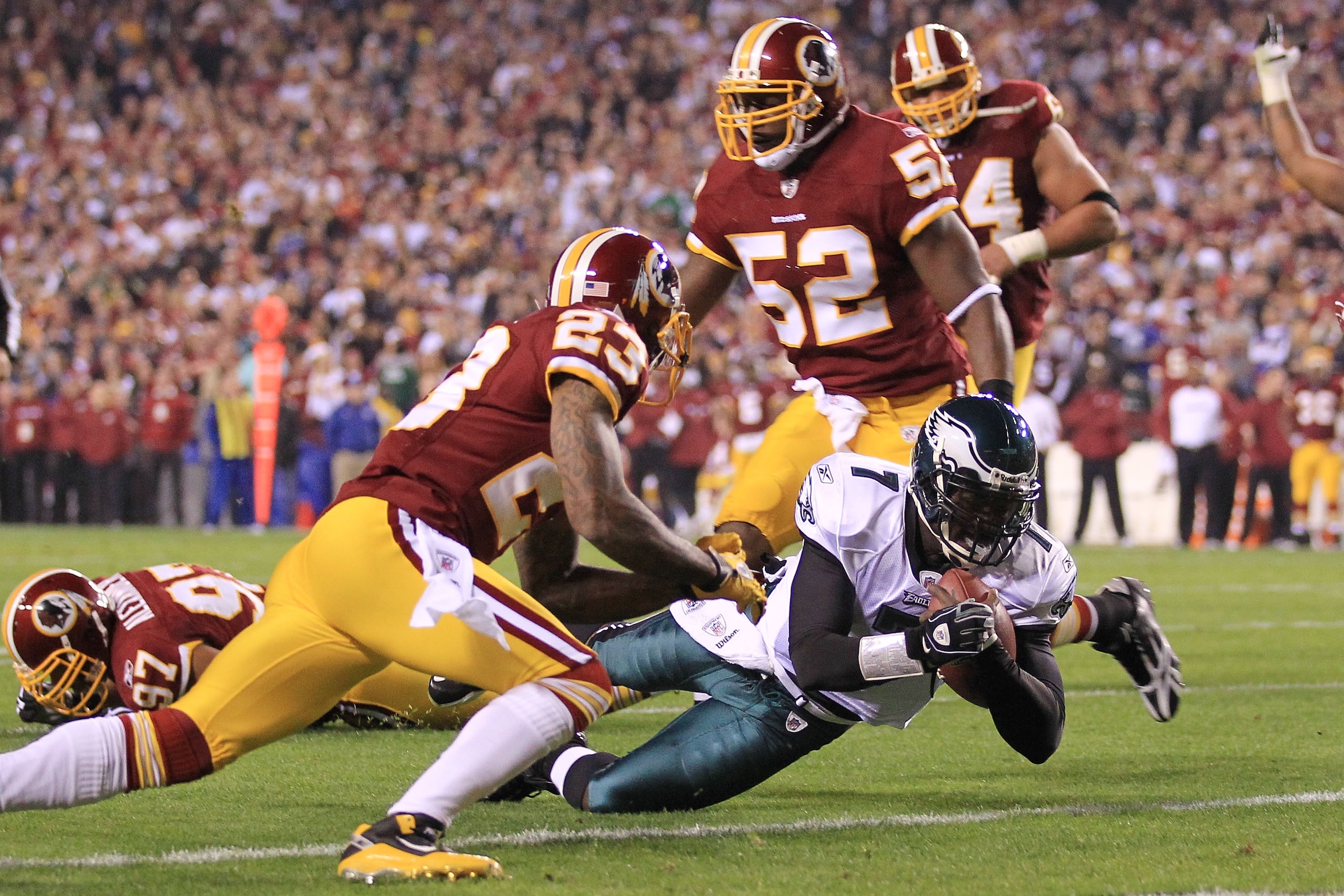 LANDOVER, MD - NOVEMBER 15:  Michael Vick #7 of the Philadelphia Eagles dives over to score a touchdown against the Washington Redskins on November 15, 2010 at FedExField in Landover, Maryland.  (Photo by Chris McGrath/Getty Images)