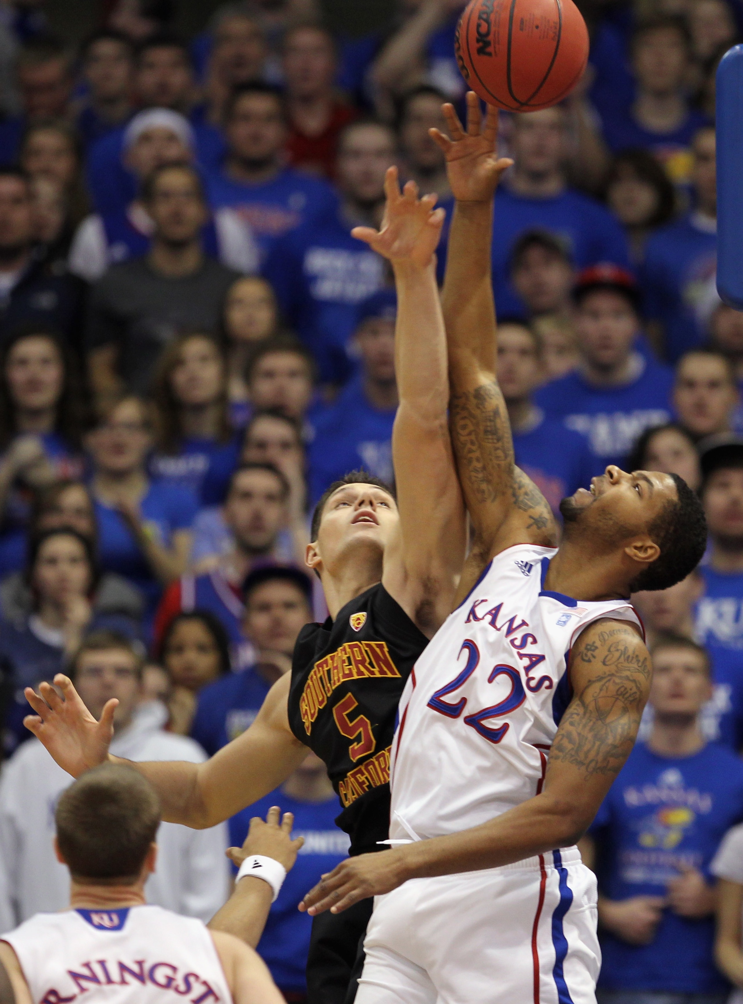LAWRENCE, KS - DECEMBER 18:  Marcus Morris #22 of the Kansas Jayhawks battles Nikola Vucevic #5 of the USC Trojans for a rebound during the game on December 18, 2010 at Allen Fieldhouse in Lawrence, Kansas.  (Photo by Jamie Squire/Getty Images)