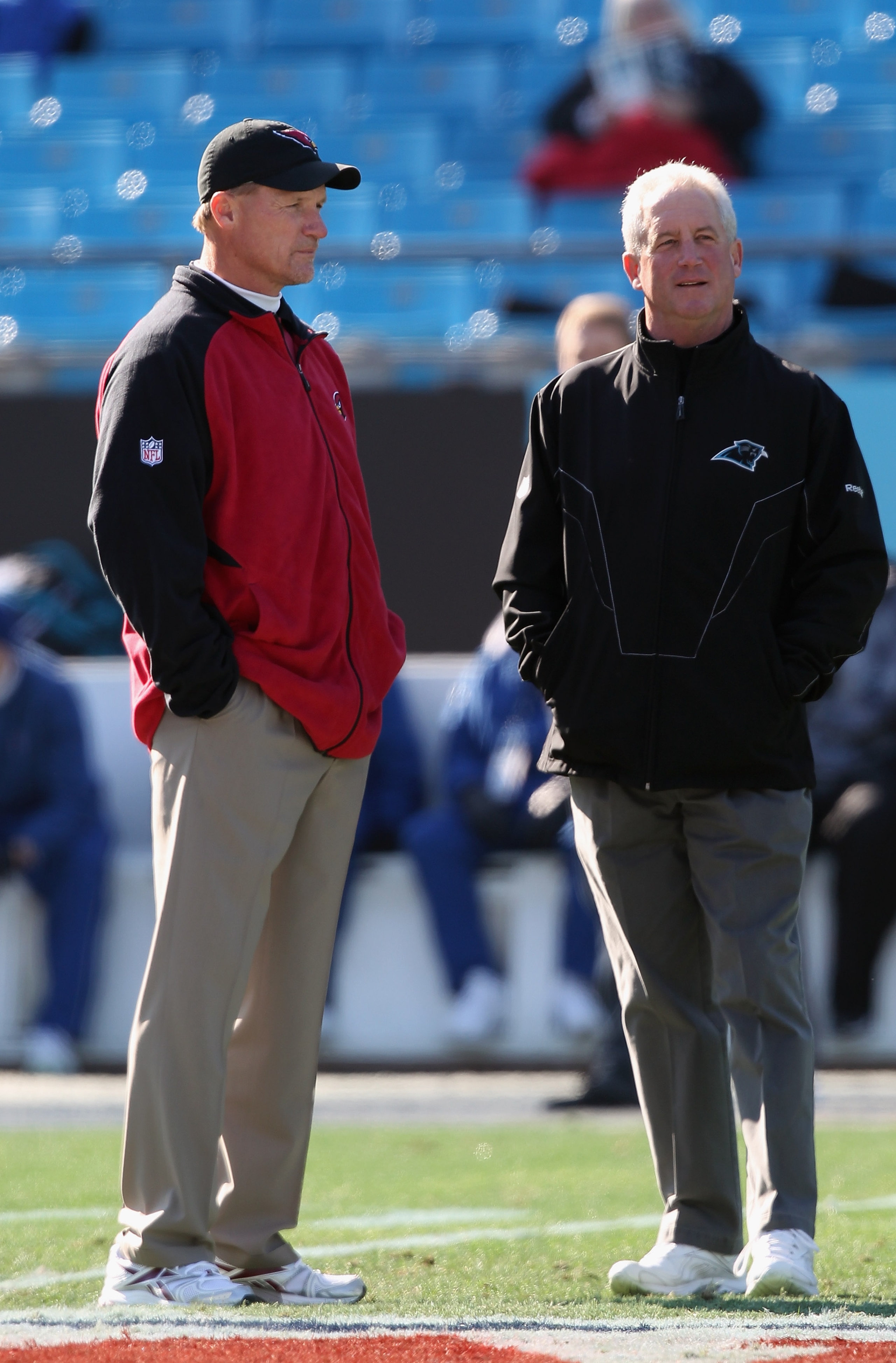 CHARLOTTE, NC - DECEMBER 19:  Head coach Ken Whisenhunt of the Arizona Cardinals talks with head coach John Fox of the Carolina Panthers before the start of their game at Bank of America Stadium on December 19, 2010 in Charlotte, North Carolina.  (Photo b